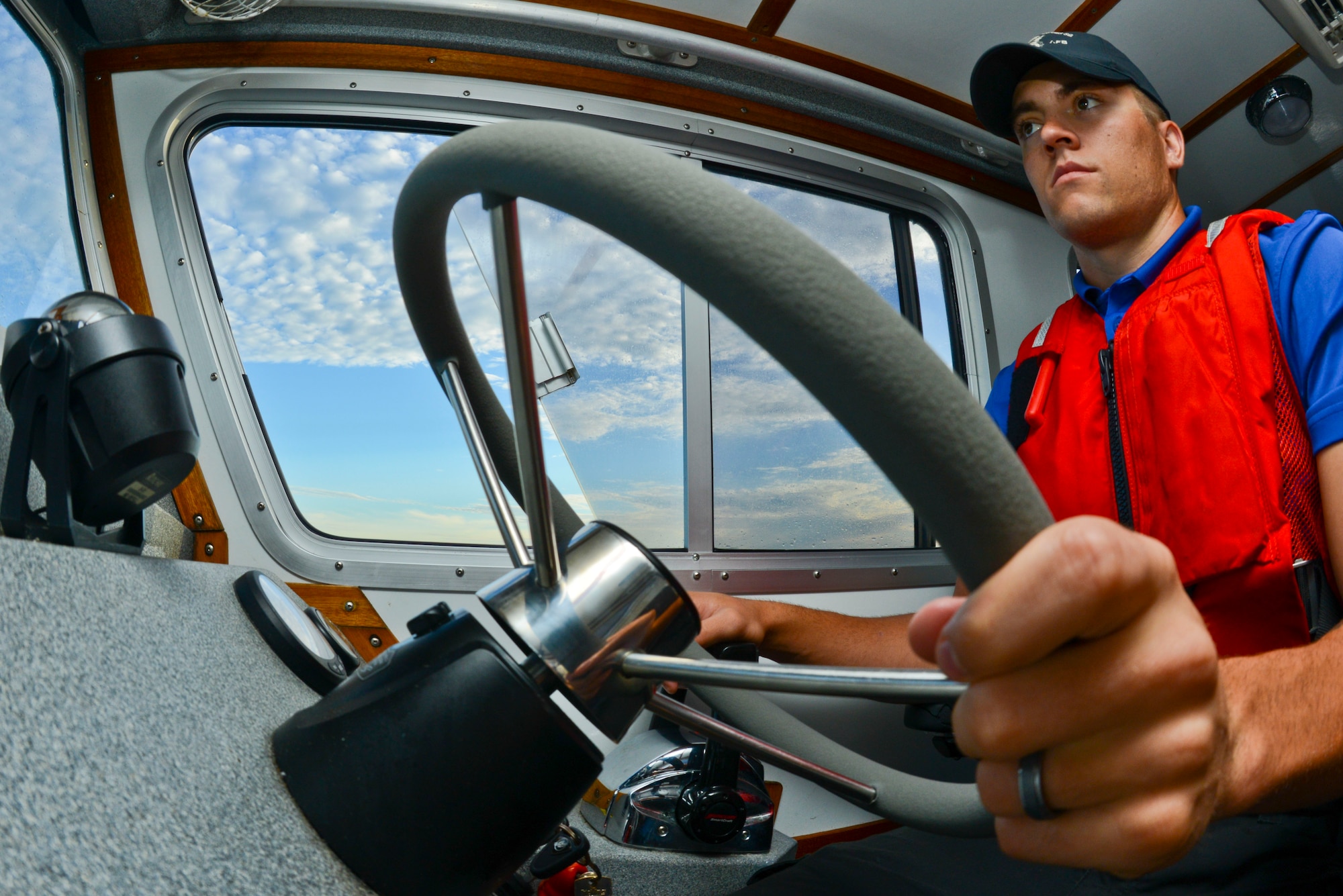 Senior Airman Cale Schumacher, 6th Security Forces Squadron marine patrolman, steers a boat through Hillsborough Bay to ensure that no person or vessel enters the restricted waters around MacDill Air Force Base, Fla., Sept. 5, 2013. The 6th SFS marine patrol was created to protect MacDill’s strategic location and many different organizations who call MacDill home. (U.S. Air Force photo by Airman 1st Class Ned T. Johnston/Released)