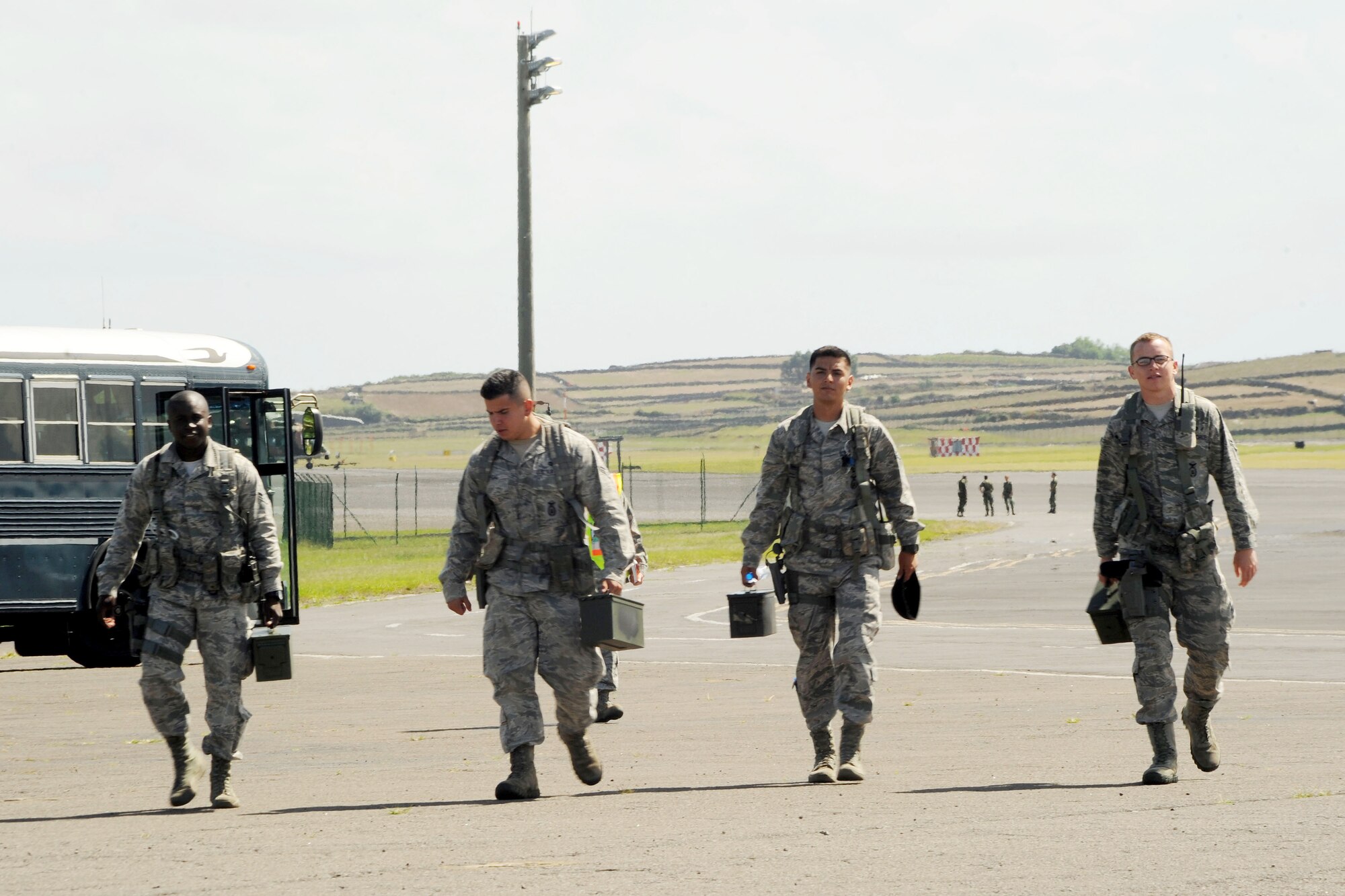 From left, U.S. Air Force Airman 1st Class Torin Hart, Senior Airman Tony Roybal and Airmen 1st Class Ismael Juarez and Zachary Handley, all 65th Security Forces Squadron specialists, leave the flight line at the end of a major accident response exercise as part of the 65th Air Base Wing’s unit effectiveness inspection Sept. 6, 2013, at Lajes Field, Azores.  The 65th ABW was rated “highly effective,” demonstrating the wing’s ability to execute its mission, measure mission effectiveness and overall compliance.   (U.S. Air Force photo by Guido Melo/Released)