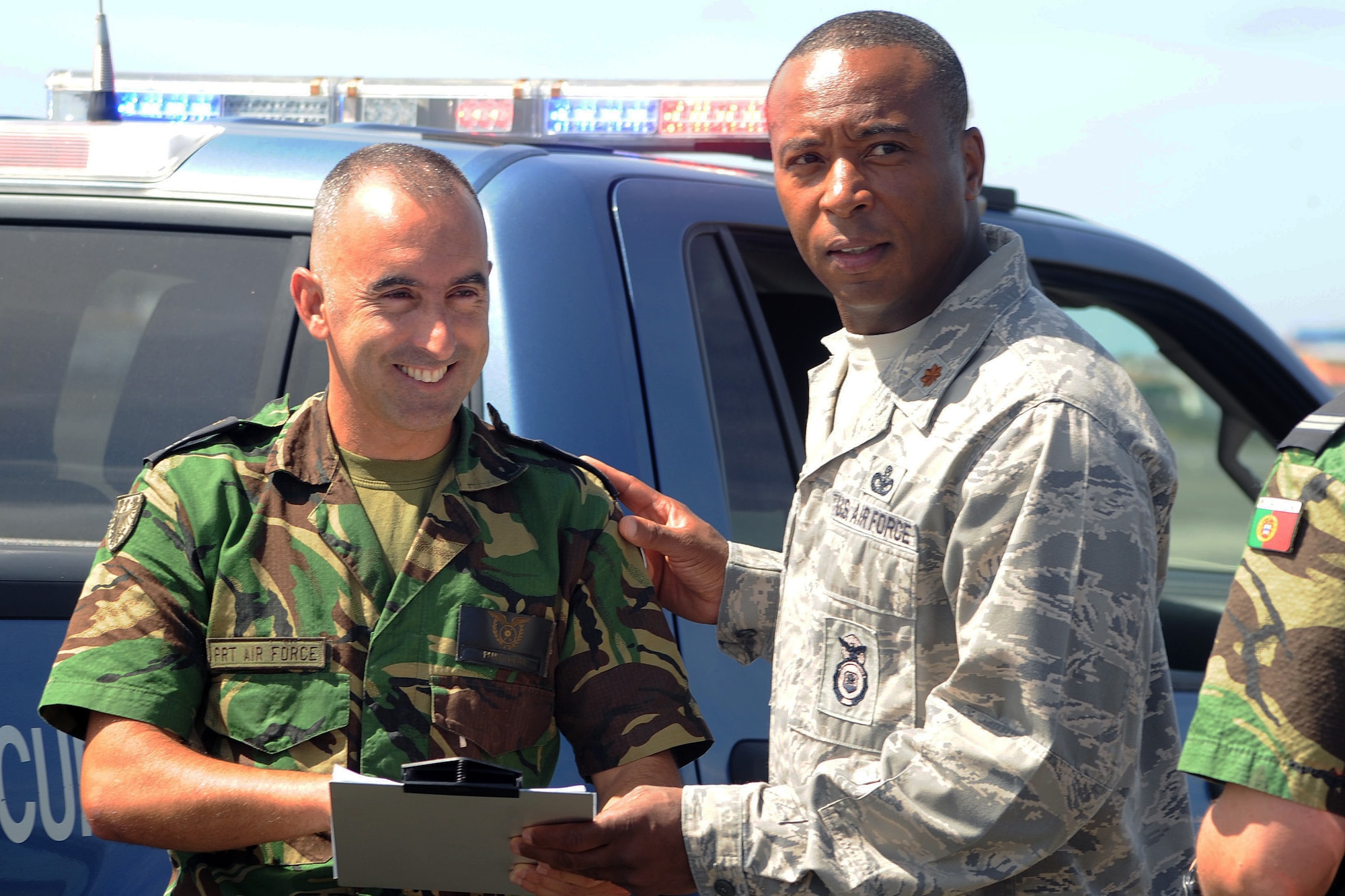 Portuguese Air Force Capt. Paulo Vieira, left, Portuguese Air Base 4 Security Forces commander, and U.S. Air Force Maj. Lawrence Wyatt, Jr., right, 65th Security Forces Squadron commander, discuss flight line security during a major accident response exercise as part of the wing’s unit effectiveness inspection Sept. 6, 2013, Lajes Field, Azores. The 65th ABW was rated “highly effective,” demonstrating the wing’s ability to execute its mission, measure mission effectiveness and overall compliance.   (U.S. Air Force photo by Guido Melo/Released)