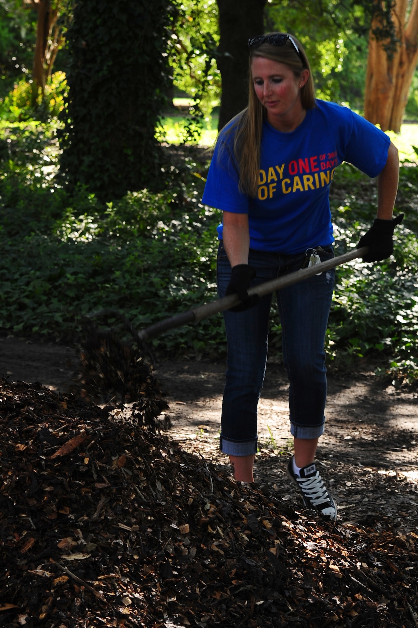 Staff Sgt. Tiffany Kirbie, 628th Logistics Readiness Squadron, shovels mulch during the annual Trident United Way’s Day of Caring Sept. 6, 2013, at Hampton Park, Charleston, S.C. Approximately 2,500 service members from Joint Base Charleston volunteered their skills to assist with more than 50 projects in the local community. (U.S. Air Force photo/ Airman 1st Class Chacarra Neal)