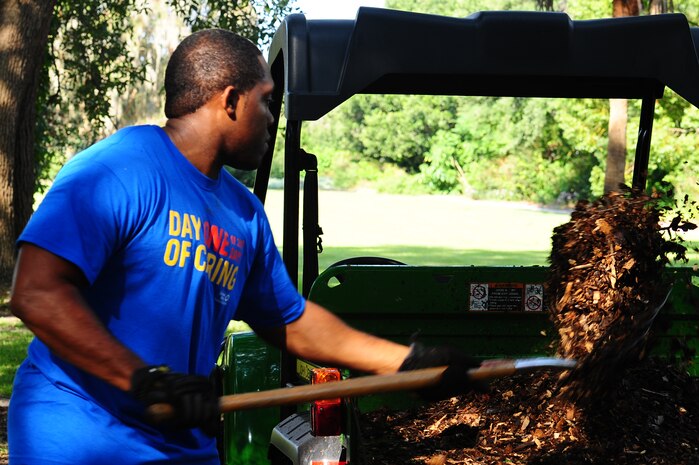 Senior Airman Kelvin Smith, 628th Aerial Medical Squadron, shovels mulch during the annual Trident United Way’s Day of Caring Sept. 6, 2013, at Hampton Park, Charleston, S.C. Approximately 2,500 service members from Joint Base Charleston volunteered their skills to assist with more than 50 projects in the local community. (U.S. Air Force photo/ Airman 1st Class Chacarra Neal)
