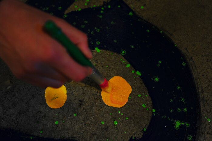 Airmen participate in the annual Trident United Way’s Day of Caring Sept. 6, 2013, at the Children's Museum of the LowCountry in Charleston, S.C. Approximately 2,500 service members from Joint Base Charleston volunteered their skills to assist with more than 50 projects in the local community. (U.S. Air Force photo/ Airman 1st Class Chacarra Neal)