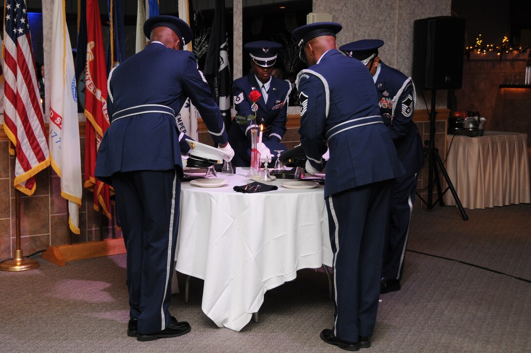 WARREN, Ohio—Members of the 910th Airlift Wing base honor guard lay branch of service caps atop empty plates on the Prisoner of War/Missing in Action table during the 910th Airlift Wing’s Air Force Birthday Dining Out here, Sept. 8.  The dining out, steeped in military tradition, was designed to recall Air Force Heritage, boost camaraderie and provide an evening of fellowship in military custom. U.S. Air Force photo by SrA Rachel Kocin.