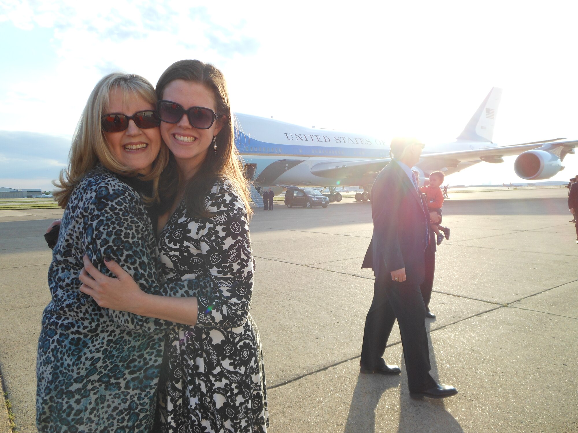 Senior Airman Katie Johnson and her mother Carolyn Maricle receive the President of the United States at Dallas/Love Field Airport, Texas April 17, 2013 before the opening of the George W. Bush presidential library. 