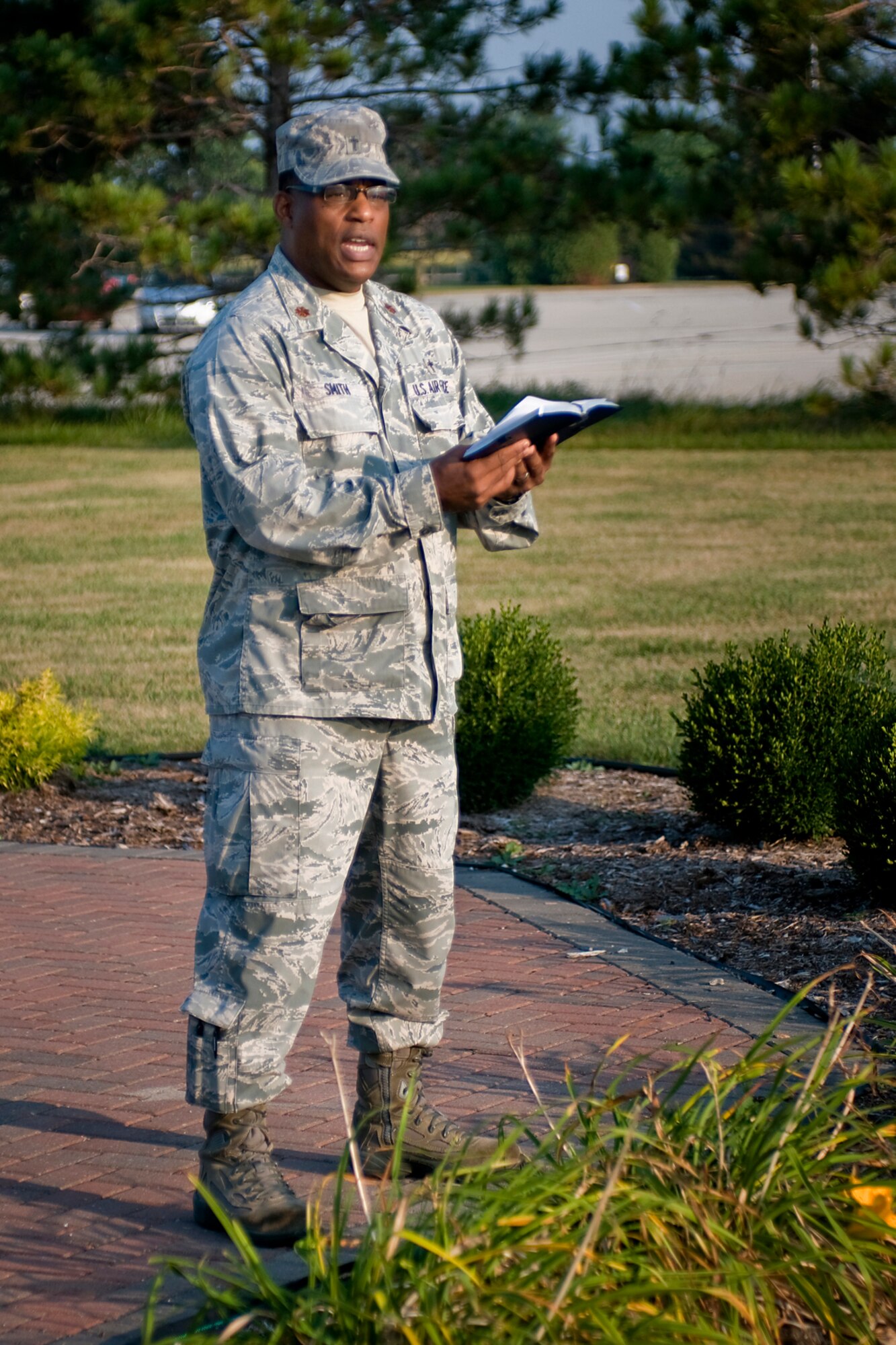 Chaplain (Maj.) Obadiah Smith Jr., 434th Air Refueling Wing chaplain, speaks to personnel assembled for a 9/11 remembrance ceremony at Grissom Air Reserve Base, Ind., Sept. 11, 2013. Civilian employees, police, firefighters and military personnel all gathered around the base flag to remember those lost in 2001 and those who have given their lives for freedom's sake ever since. (U.S. Air Force photo/Tech. Sgt. Mark R. W. Orders-Woempner) 
