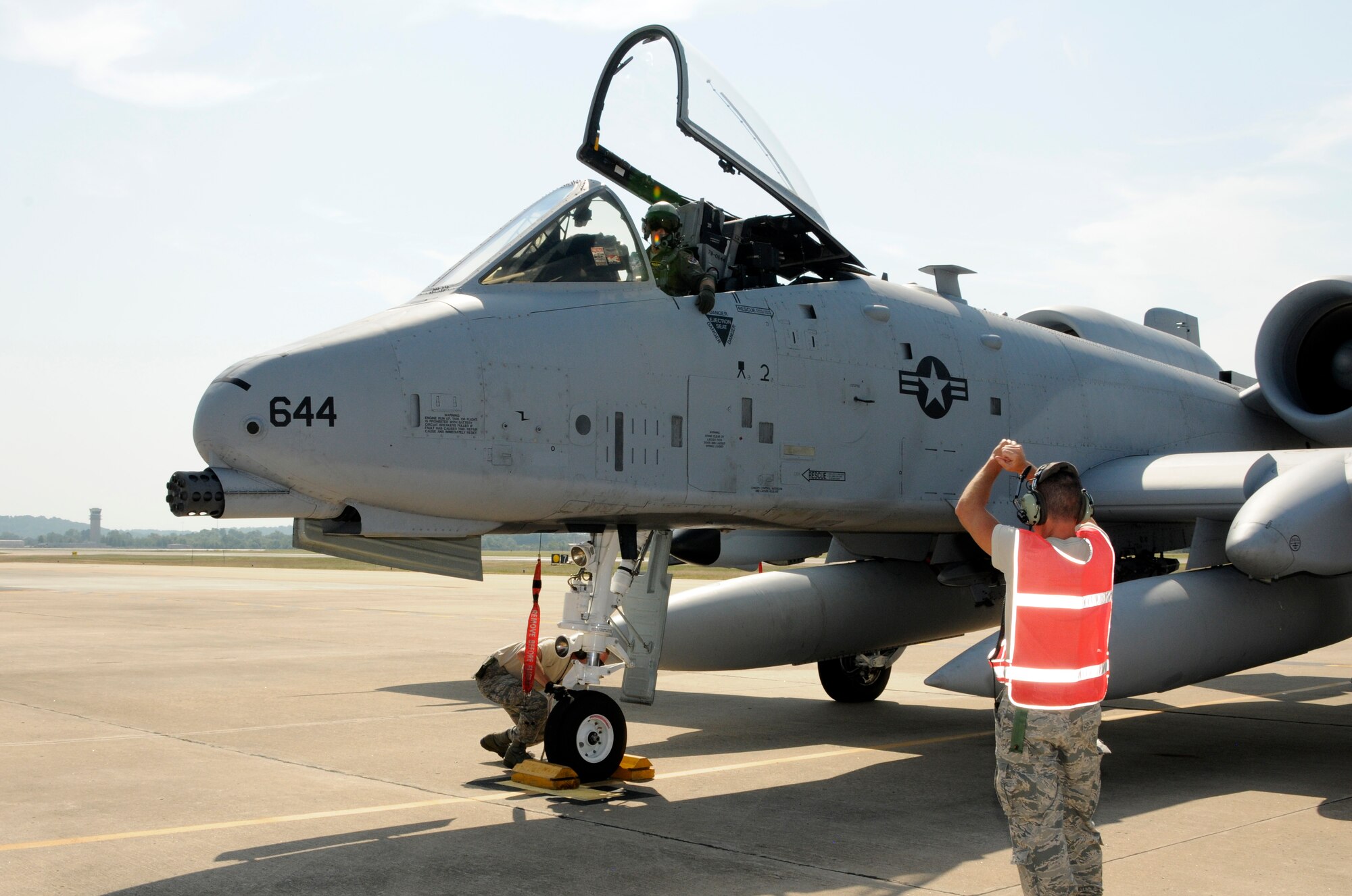 A crew chief with the 188th Aircraft Maintenance Squadron, prepares to marshal an A-10C Thunderbolt II “Warthog,” Sept. 10 following an end-of-runway inspection at Ebbing Air National Guard Base in Fort Smith, Ark. The pilot, a member of Moody Air Force Base’s 75th Fighter Squadron, flew Tail No. A0644 back to Georgia, signaling the beginning of the end for the 188th’s fighter mission. The 188th will lose two Warthogs a month until the last two leave in June 2014. The 188th is in the beginning stages of converting from A-10s to an Intelligence and remotely piloted aircraft mission. The mission, which will feature the MQ-9 Reaper, will also boast the Air National Guard’s only space-focused targeting squadron. (U.S. Air National Guard photo by Senior Airman Hannah Landeros/188th Fighter Wing Public Affairs)