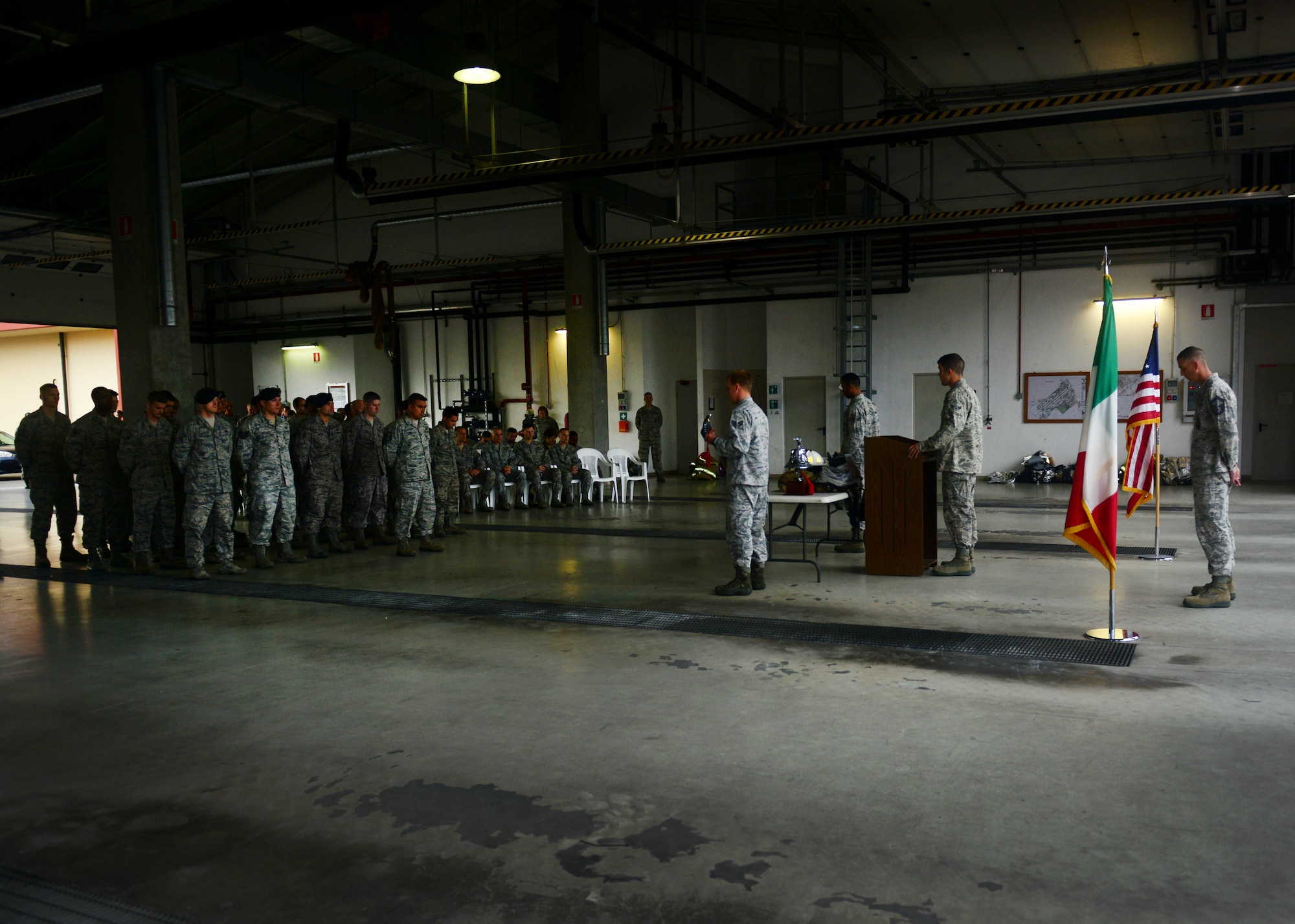 Firefighters from the 31st Civil Engineer Squadron and defenders from the 31st Security Forces Squadron, pay respect to honor military and civilian heroes, who lost their lives on 9/11, during a remembrance ceremony Sept. 11, 2013, at Aviano Air Base, Italy. During the event the Firefighter Prayer was recited with the ringing of the last alarm, a tradition that honors those who gave their lives in the line of duty. (U.S. Air Force photo/Staff Sgt. Evelyn Chavez)
