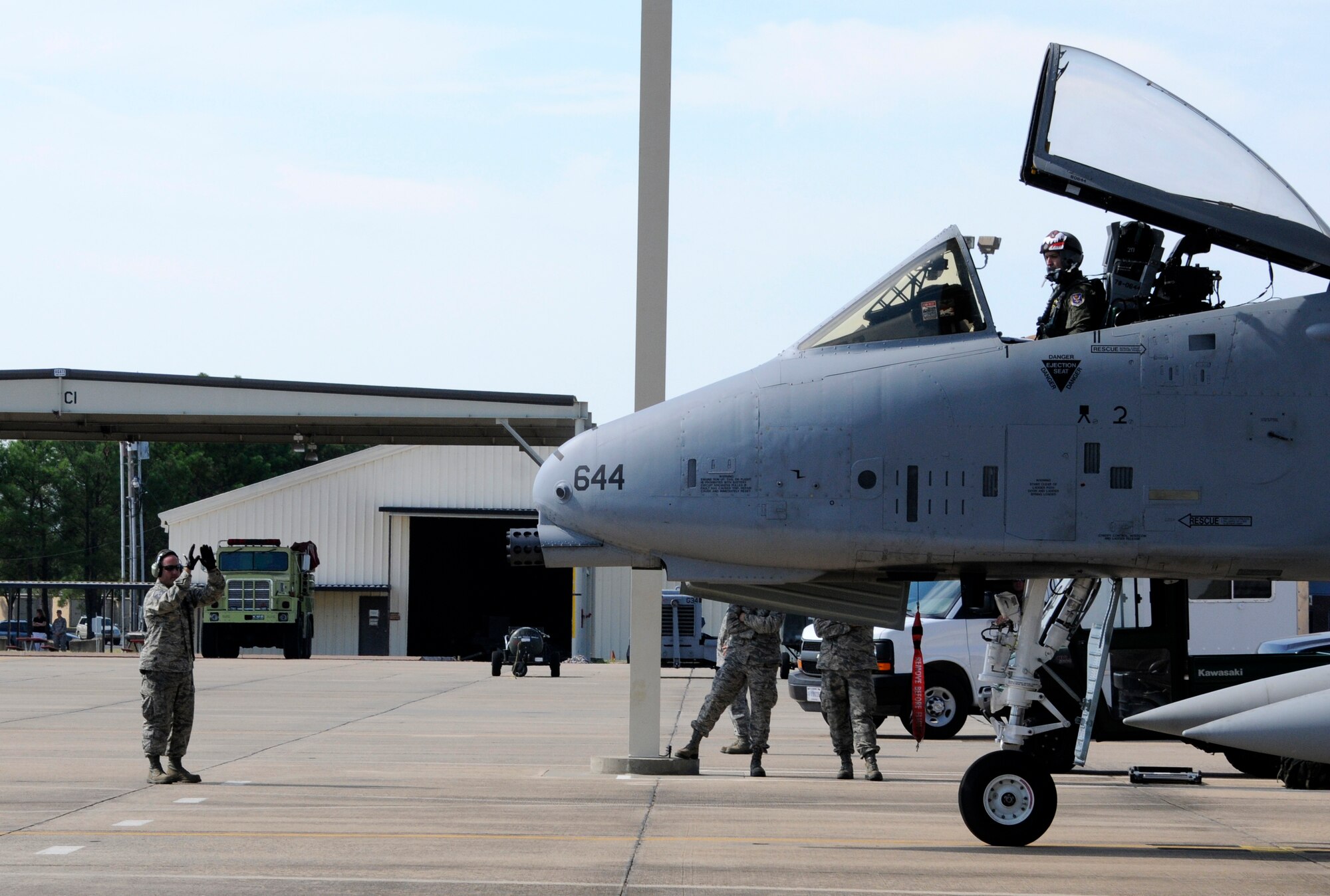 Master Sgt. Haden Key, a crew chief with the 188th Aircraft Maintenance Squadron, prepares to marshal an A-10C Thunderbolt II “Warthog,” Sept. 10 at Ebbing Air National Guard Base in Fort Smith, Ark. The pilot, a member of Moody Air Force Base’s 75th Fighter Squadron, flew Tail No. A0644 back to Georgia, signaling the beginning of the end for the 188th’s fighter mission. The 188th will lose two Warthogs a month until the last two leave in June 2014. The 188th is in the beginning stages of converting from A-10s to an Intelligence and remotely piloted aircraft mission. The mission, which will feature the MQ-9 Reaper, will also boast the Air National Guard’s only space-focused targeting squadron. (U.S. Air National Guard photo by Senior Airman Hannah Landeros/188th Fighter Wing Public Affairs)