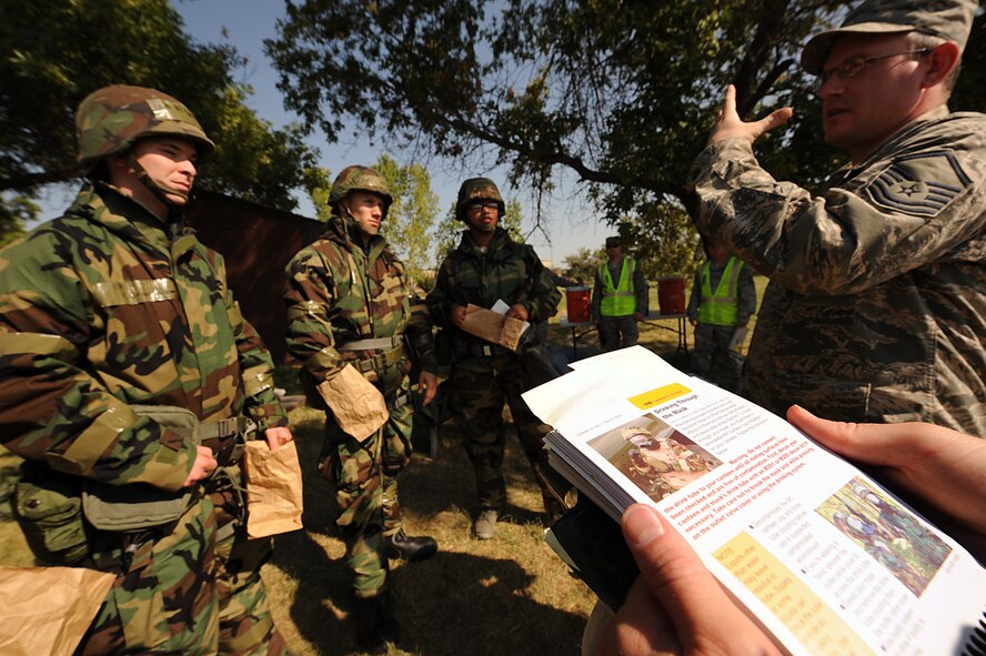 Airmen from the 5th Aircraft Maintenance Squadron participate in a general task qualification training course during an exercise at Minot Air Force Base, N.D., Sept. 5. More than 100 personnel from the 5th Maintenance Group were trained on various tactical techniques and procedures, including donning their chemical warfare ensemble; hydrating in Mission Oriented Protective Posture 4; performing an unexploded ordnance sweep; applying contamination avoidance techniques, and processing through mock contamination controlled areas. (U.S. Air Force photo/Senior Airman Stephanie Sauberan)