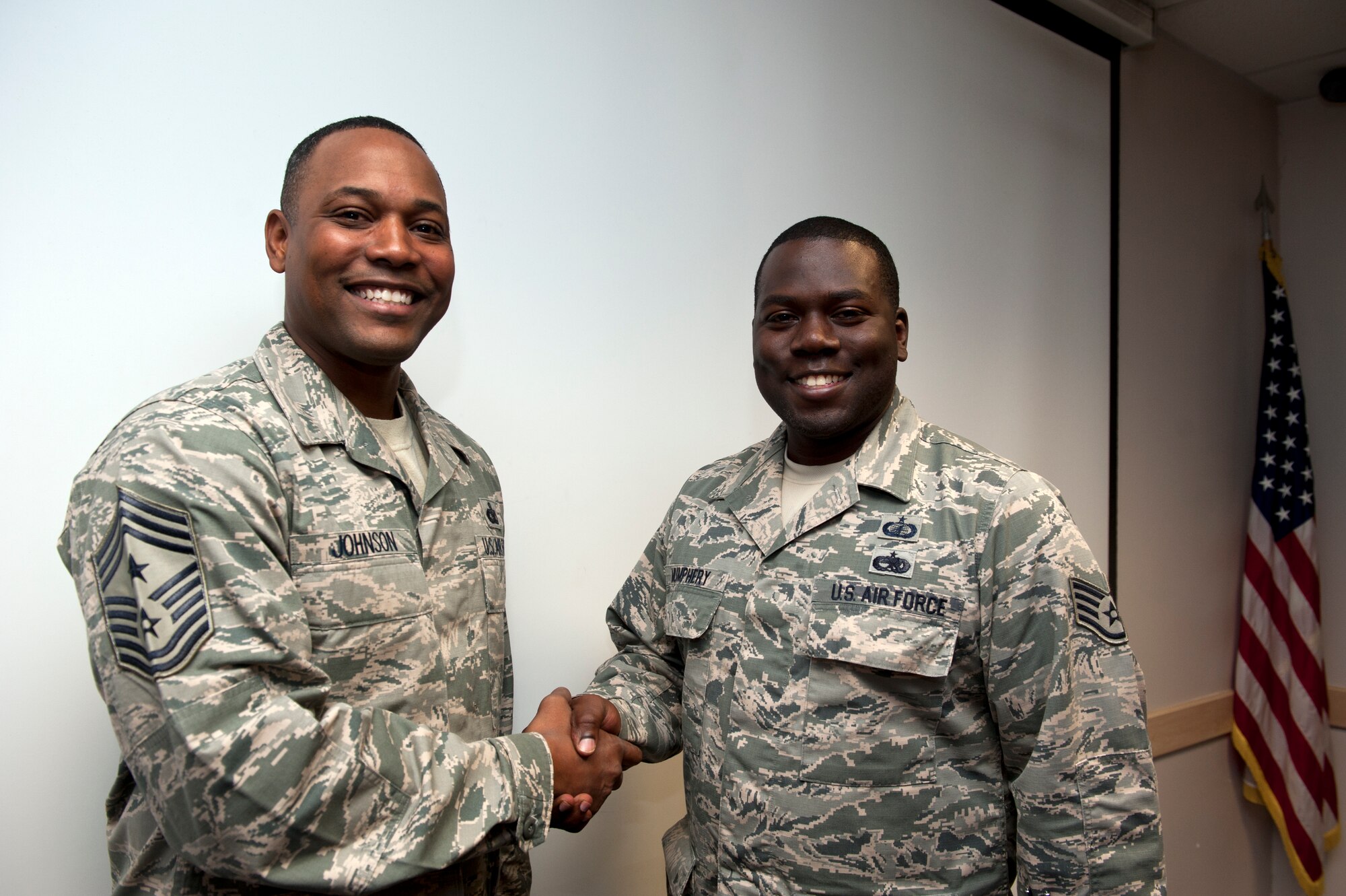 Staff Sgt. Qytravious Mumphery, 39th Contracting Squadron contracting administrator, receives a coin from Chief Master Sgt. Anthony Johnson, 39th Air Base Wing command chief, after being recognized for his outstanding work Sept. 11, 2013, at Incirlik Air Base, Turkey. "Pick of the 'Lik’" recognizes outstanding members of Team Incirlik who display a commitment to excellence. Airmen are nominated by their squadron supervision and selected by 39th Air Base Wing senior leadership for recognition. (U.S. Air Force photo by Senior Airman Daniel Phelps/Released)
