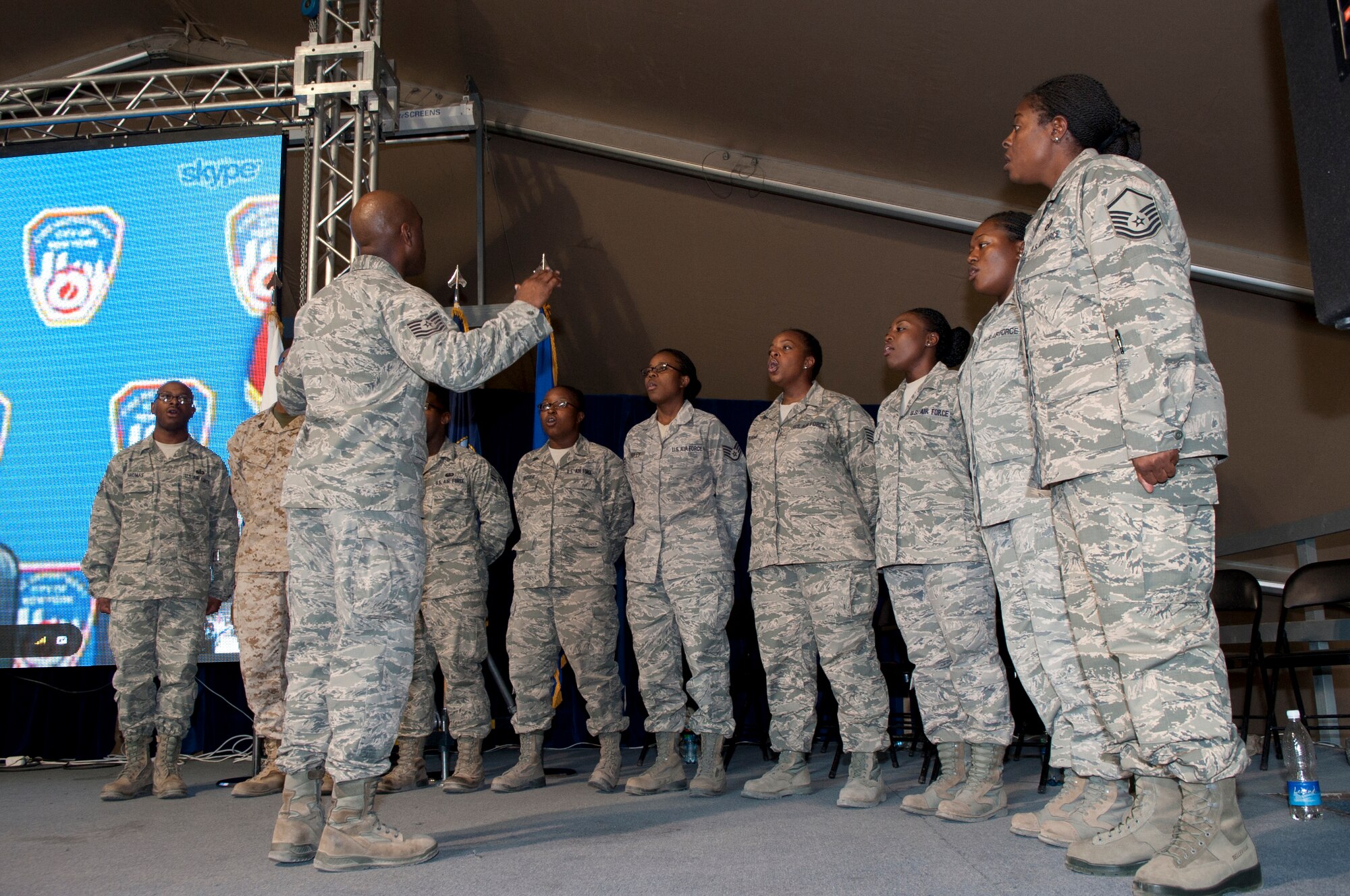 The Gospel Service Praise and Worship Team sings the National Anthem during the 9/11 Memorial Ceremony at Transit Center at Manas, Kyrgyzstan, Sept. 11, 2013. This event was the first time the praise and worship team performed during an official ceremony at the Transit Center. (U.S. Air Force photo/Staff Sgt. Robert Barnett)