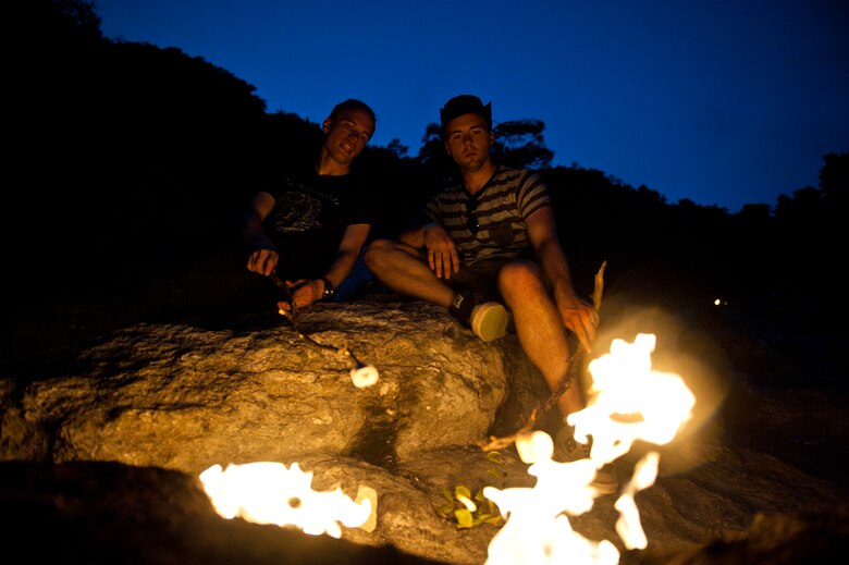 Chase Hedrick and Brandon Sabin, visitors to Chimaera, roast marshmallows in the “eternal flame” Sept. 2, 2013, near Antalya, Turkey. Directly below the fires are the ruins of a temple to Hephaistos, the Greek god who forged Zeus’ thunderbolt . (U.S. Air Force photo by Senior Airman Daniel Phelps/Released)
