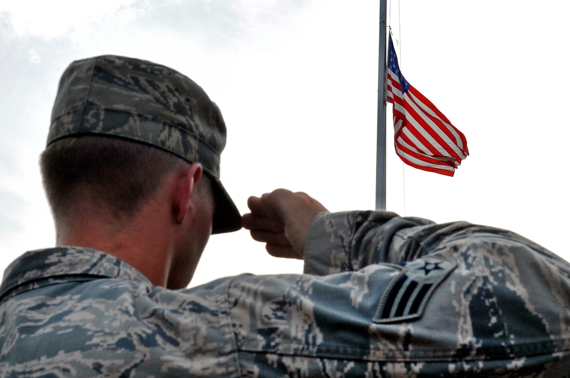 U.S. Air Force Senior Airman Brent Points, 35th Civil Engineer Squadron Explosive Ordnance Disposal apprentice, salutes during the Patriot Day Retreat Ceremony at Misawa Air Base, Japan, Sept. 11, 2013. Points along with other first responders from the 35 CES, 35th Security forces Squadron and the 35th Medical Group, gathered to honor those who died during the attacks on Sept. 11, 2001. (U.S. Air Force photo by Airman 1st Class Zachary Kee)