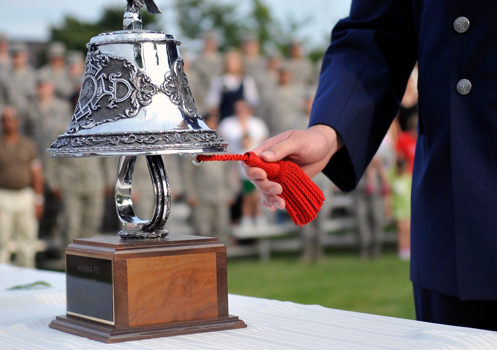 U.S. Air Force Senior Airman Zackary Sandoval, 35th Civil Engineer Squadron firefighter, rings the last alarm during the Patriot Day Retreat Ceremony at Misawa Air Base, Japan, Sept. 11, 2013. Fire Departments sound a series of bells when a firefighter dies in the line of duty to alert all members that a comrade made the ultimate sacrifice. The 35th Fighter Wing held this retreat ceremony to pay respect and remember those who were affected by the tragic events that occurred 12 years ago. (U.S. Air Force photo by Airman 1st Class Zachary Kee)