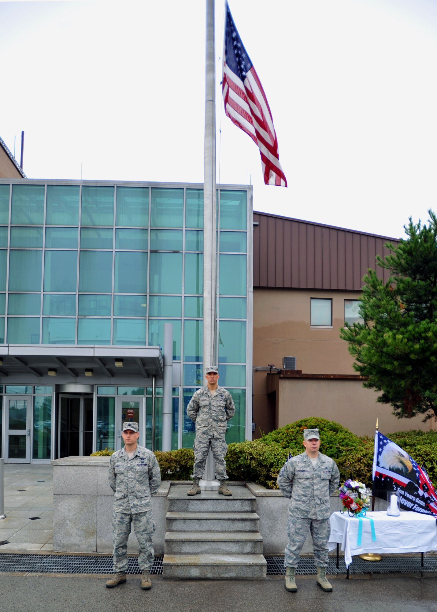 Col. Sean DeWitt, 51st Fighter Wing vice commander, Col. Brook Leonard, 51st FW commander, and Chief Master Sgt. Brendan Criswell, 51st FW command chief, stand at parade rest as part of the 24-hour vigil after the 9/11 memorial ceremony at Osan Air Base, Republic of Korea, Sept. 11, 2013. At the end of the ceremony, the 51st FW’s leadership stood at the vigil for 30 minutes – the first of 48 three-man teams to do so in honor of those that lost their lives during the attacks 12 years ago. (U.S. Air Force photo/Senior Airman Siuta B. Ika)