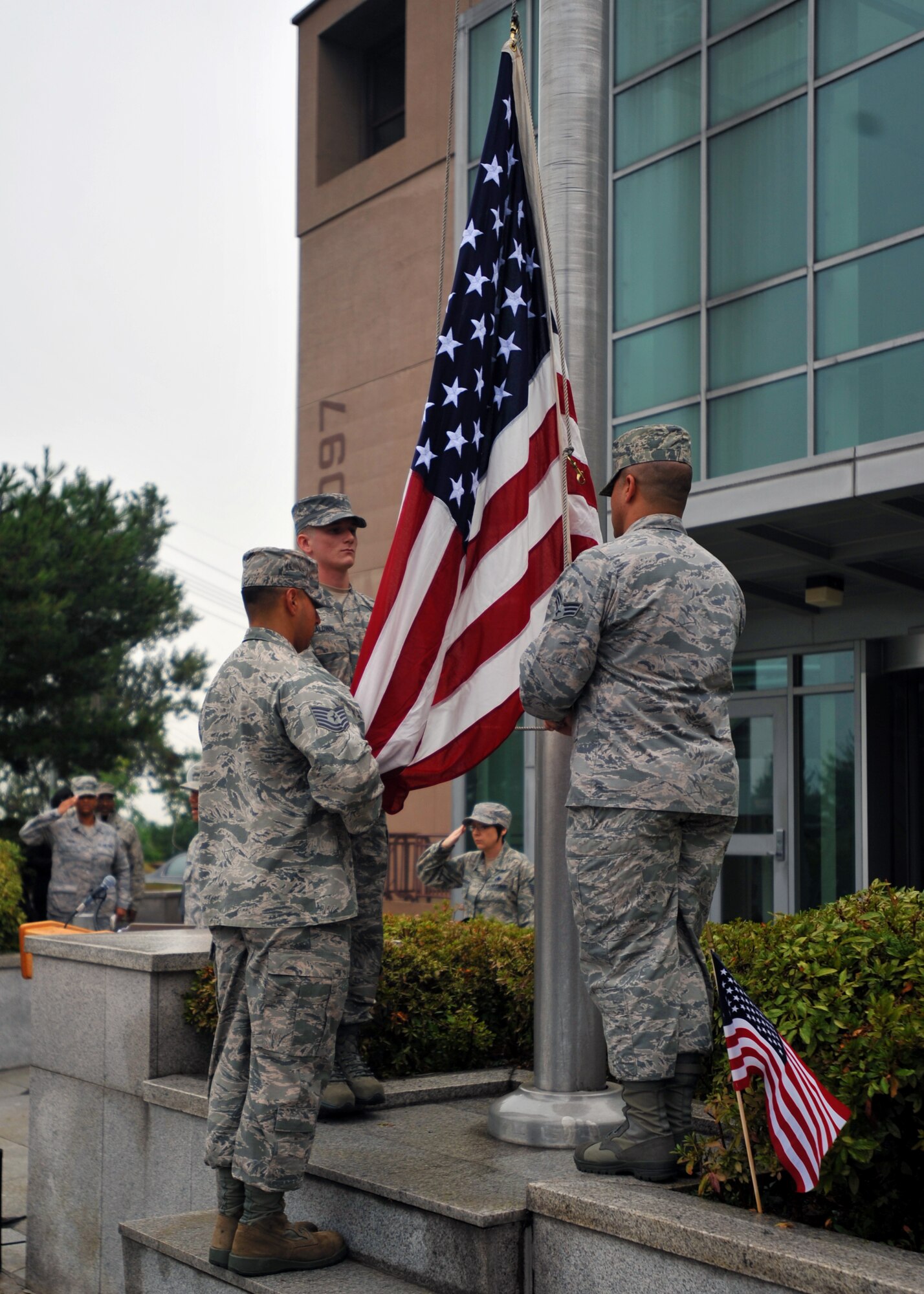 Members of the Osan Honor Guard put up the American flag during the beginning of the 9/11 memorial ceremony at Osan Air Base, Republic of Korea, Sept. 11, 2013. This year marks the 12th anniversary of 9/11, and the ceremony provided an opportunity for all to reflect and remember those tragic events that challenged the nation’s resolve. (U.S. Air Force photo/Senior Airman Siuta B. Ika)