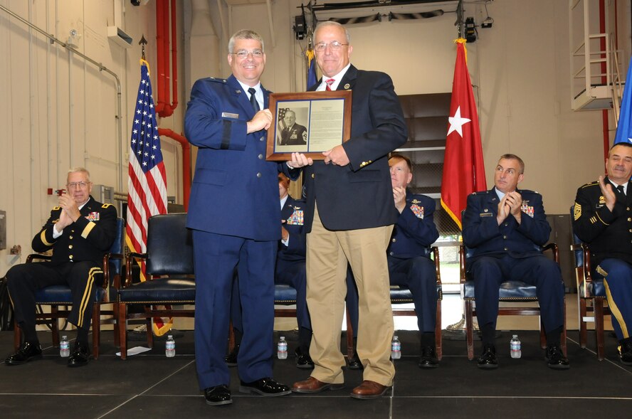 Deputy Adjutant General - Air, Brig. Gen. Tony Carrelli, left, presents retired Chief Master Sgt. Dale Bashore with a plaque for being inducted into the Pennsylvania Air National Guard Hall of Fame during the PA ANG Flight of Freedom ceremony. During the ceremony Airmen and units are recognized for their achievements over the past year. This year the ceremony was hosted in Middletown, Pa., by the 193rd SOW, Sept. 8. (U.S. Air National Guard photo by Senior Master Sgt. David Hawkins/Released)