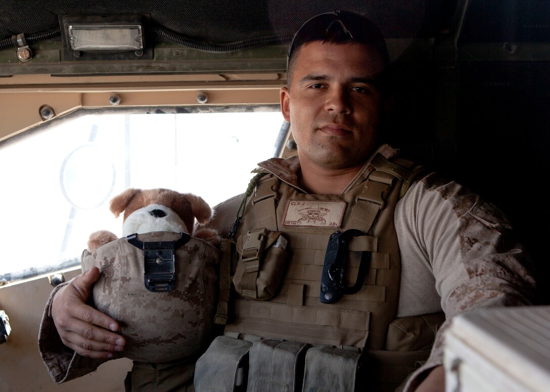 Marine Corps Sgt. Anthony Ortiz with a teddy bear during a patrol in Afghanistan’s Helmand province, Aug. 13, 2013. Courtesy photo