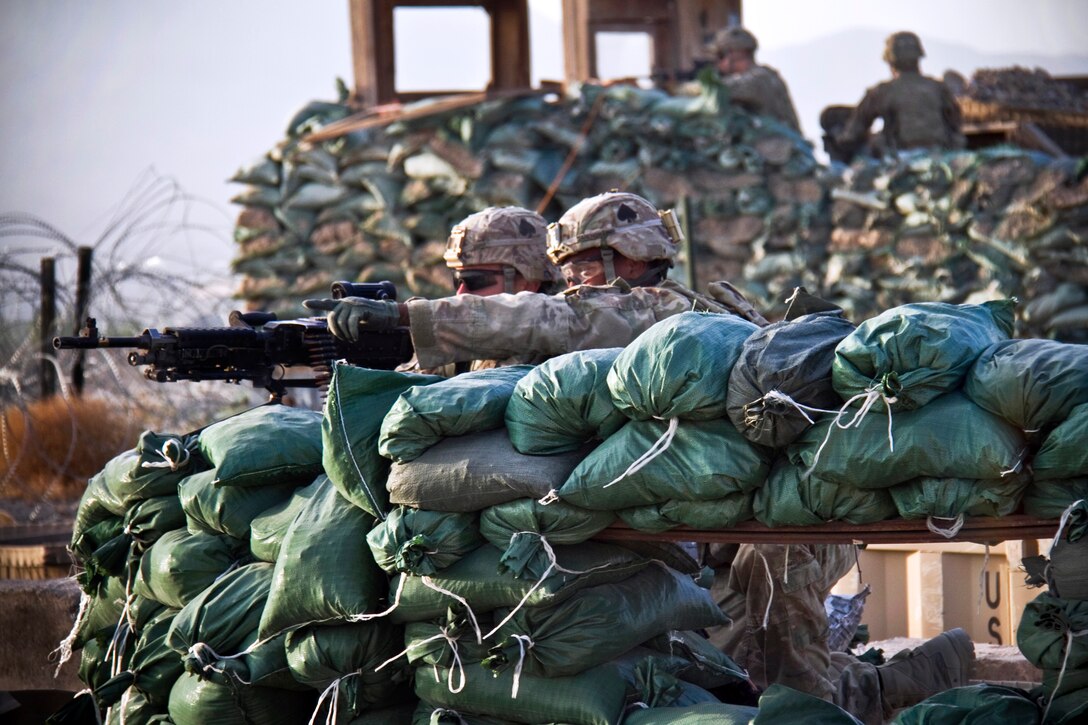 A U.S. soldier points in the direction of a possible threat to a machine gunner during a vehicle-born improvised explosive device drill on Forward Operating Base Gardez in Afghanistan's Paktya province, Aug. 29, 2013.