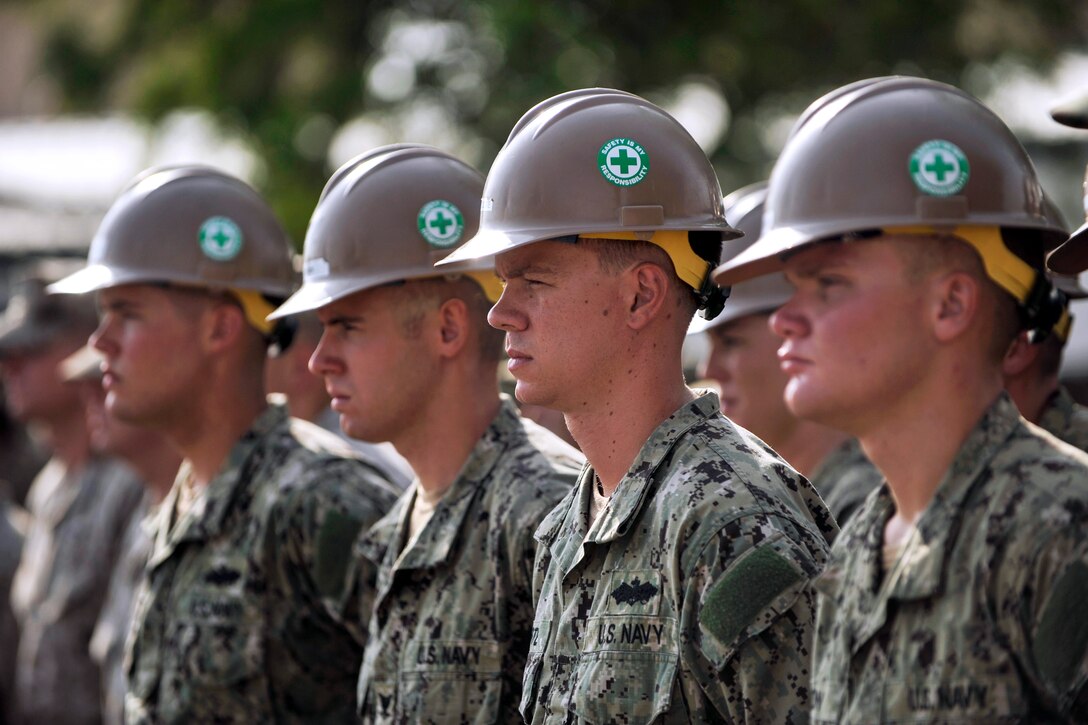 U.S. Navy Seabees stand in formation during a 9/11 commemoration ceremony on Camp Lemonnier, Djibouti, Sept. 11, 2013. The Seabees are assigned to Naval Mobile Construction Battalion 11.