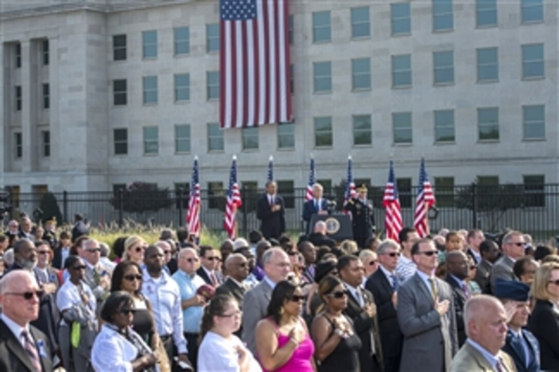 President Barack Obama, Secretary of Defense Chuck Hagel, Chairman of the Joint Chiefs of Staff Gen. Martin Dempsey and members of the audience salute and place their hands over their heart as the National Anthem is played during a remembrance ceremony to honor the victims of the 9/11 attacks on the Pentagon in Arlington, Va., on Sept. 11, 2013.  Obama, Hagel and Dempsey joined family members of those killed in the terrorist attack twelve years ago to remember and mark the anniversary.  