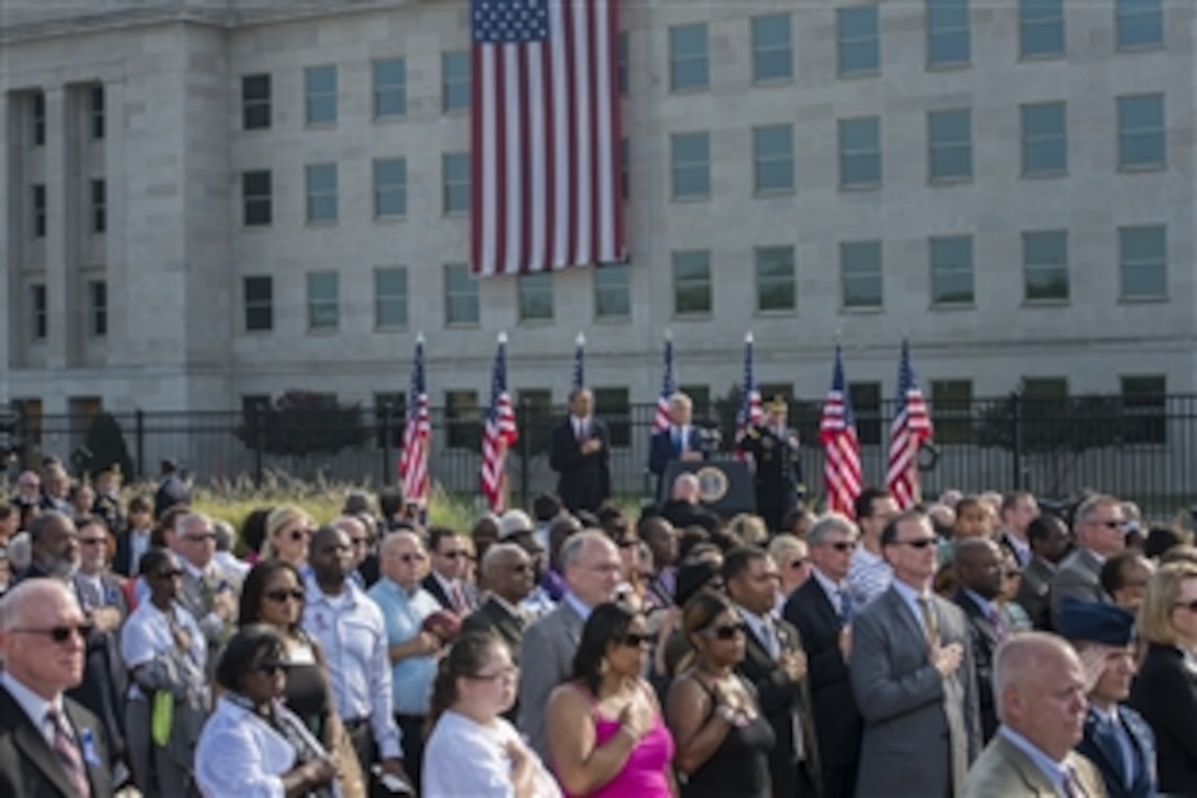 President Barack Obama, left, Defense Secretary Chuck Hagel and Army Gen. Martin E. Dempsey, chairman of the Joint Chiefs of Staff, stand during the playing of the national anthem to honor those killed in the 9/11 terrorist attack at the Pentagon during a remembrance ceremony at the Pentagon Memorial, Sept. 11, 2013.
