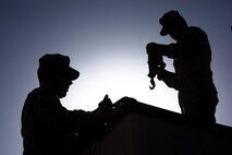 Two Marines with Combat Logistics Regiment 2, Regional Command (Southwest), unhook a cargo load at Forward Operating Base Shir Ghazi, Helmand province, Afghanistan, Aug. 27, 2013. The Marines took part in a combat logistics patrol to deliver supplies to Marines throughout the area while simultaneously conducting backhaul operations.