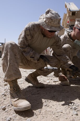 A Marine with Combat Logistics Regiment 2, Regional Command (Southwest), fixes an anchor point on a load trailor at Forward Operating Base Now Zad, Helmand province, Afghanistan, Aug. 28, 2013. The regiment took part in a combat logistics patrol to deliver supplies to Marines throughout the area while simultaneously conducting backhaul operations.