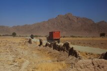 A convoy conducted by Combat Logistics Regiment 2, Regional Command (Southwest), carries supplies down a desert road near Forward Operating Base Now Zad, Helmand province, Afghanistan, Aug. 28, 2013. The regiment took part in a combat logistics patrol to deliver supplies to Marines throughout the area while simultaneously conducting backhaul operations.