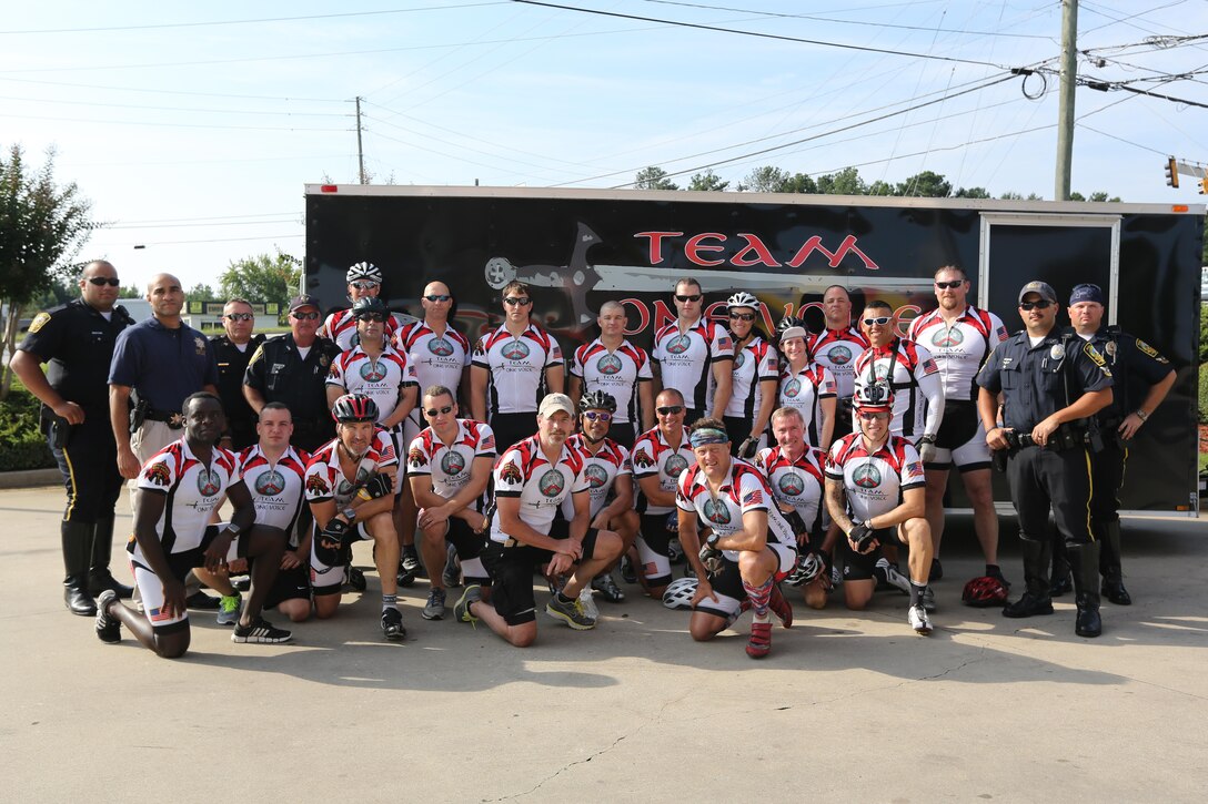 Servicemembers, members of the Gwinnett Sheriffs department and Georgia State Trooper pose for a picture at the half-way point during the third day of the Operation One Voice Honor Ride, Sept. 6, 2013. Marines with U.S. Marine Corps Forces Special Operations Command were invited to ride in the Honor Ride to support wounded and deceased veteran members of the U.S. Special Operations community.The Honor Ride this year was a 450-mile bike ride over a four day period. (U.S. Marine Corps photo by Sgt. Anthony Carter/Released)