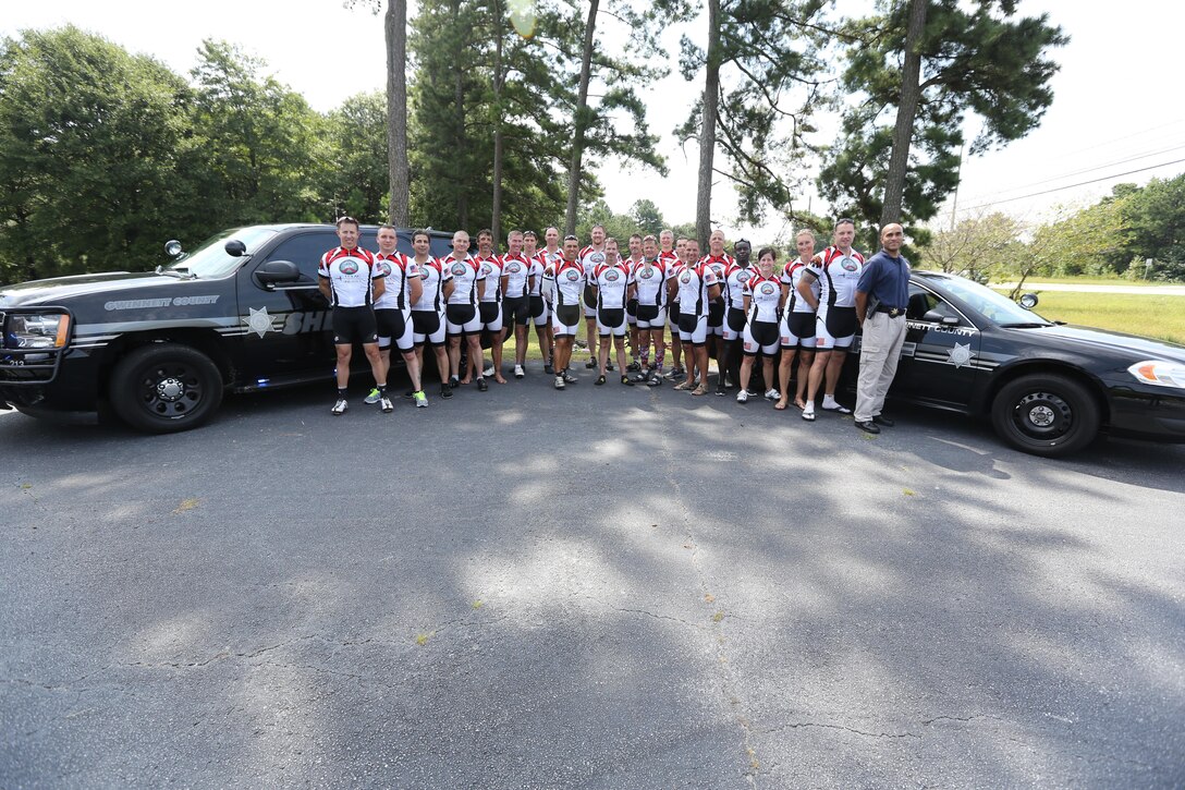 Servicemembers, members of the Gwinnett Sheriffs department and Georgia State Trooper pose for a picture after completing the third day of the Operation One Voice Honor Ride, Sept. 6, 2013. Marines with U.S. Marine Corps Forces Special Operations Command were invited to ride in the Honor Ride to support wounded and deceased veteran members of the U.S. Special Operations community.The Honor Ride this year was a 450-mile bike ride over a four day period. (U.S. Marine Corps photo by Sgt. Anthony Carter/Released)