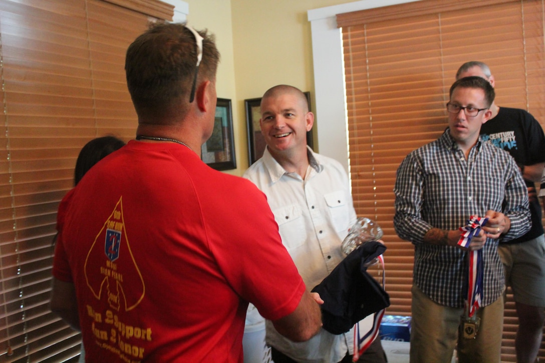 Major Gen. Mark A. Clark, commander, U.S. Marine Corps Forces, Special Operations Command, congratulates Master Chief Petty Officer Jody G. Fletcher, command master chief, MARSOC, during the bike completion ceremony after the final day of riding during the Operation One Voice Honor Ride, Sept. 6, 2013. Marines with U.S. Marine Corps Forces Special Operations Command were invited to ride in the Honor Ride to support wounded and deceased veteran members of the U.S. Special Operations community.The Honor Ride this year was a 450-mile bike ride over a four day period. (U.S. Marine Corps courtesy photo/Released)