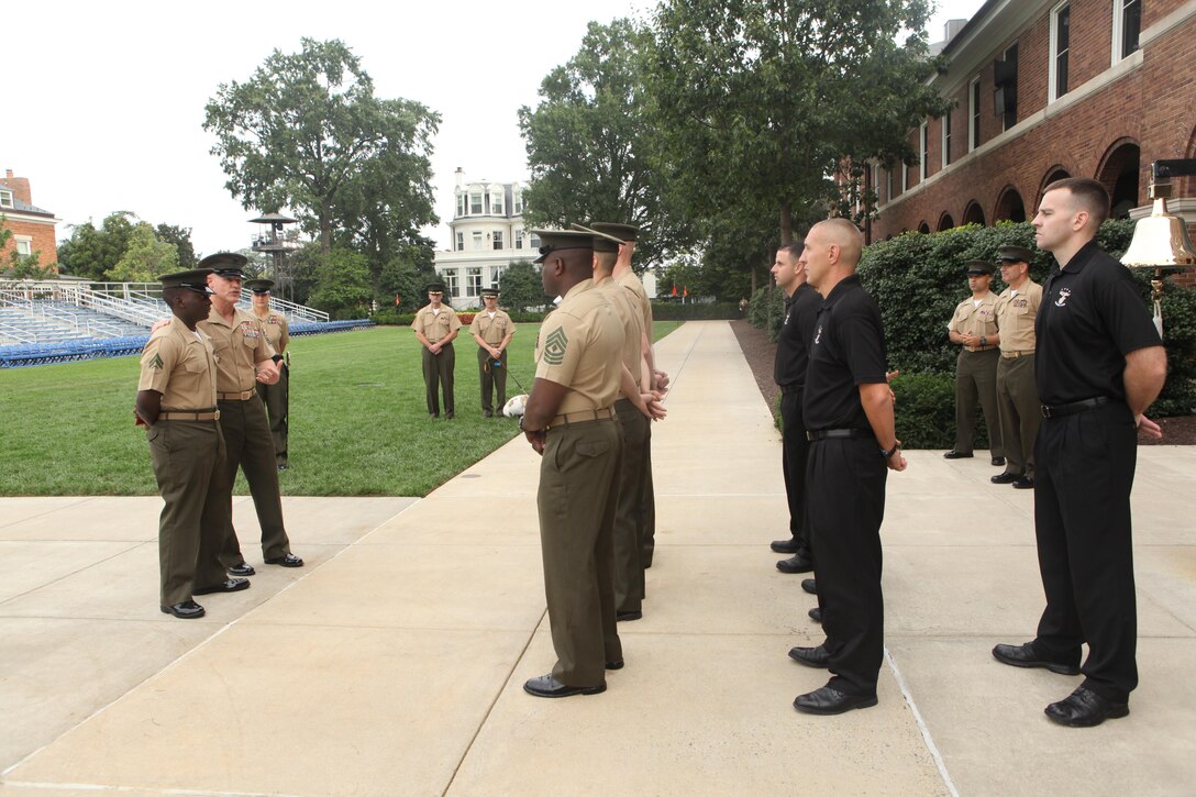 Sgt. Maj. Micheal P. Barrett, the 17th Sergeant Major of the Marine Corps, presents Cpl. Dijon Terry with a certificate of commendation at Marine Barracks Washington, D.C., on Aug. 30, 2013. (U.S. Marine Corps photo by Sgt. Marionne T. Mangrum)