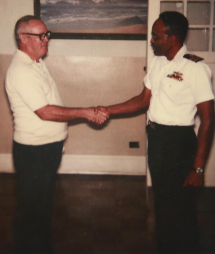Howard C. Broseker shakes the hand of the commanding officer at the Naval Radio Transmitting Facility Annapolis Naval Station, North Severn in Annapolis, Md. at his retirement in 1986.  The transmitting facility supports the establishment and operation of a transatlantic communication system. Broseker continued to serve fellow military members by working in the civil service sector for an additional 30 years after serving 31 years in the Navy and Air Force. Broseker is a 90-year-old war veteran who thrives on love for his fellow service members and family.
