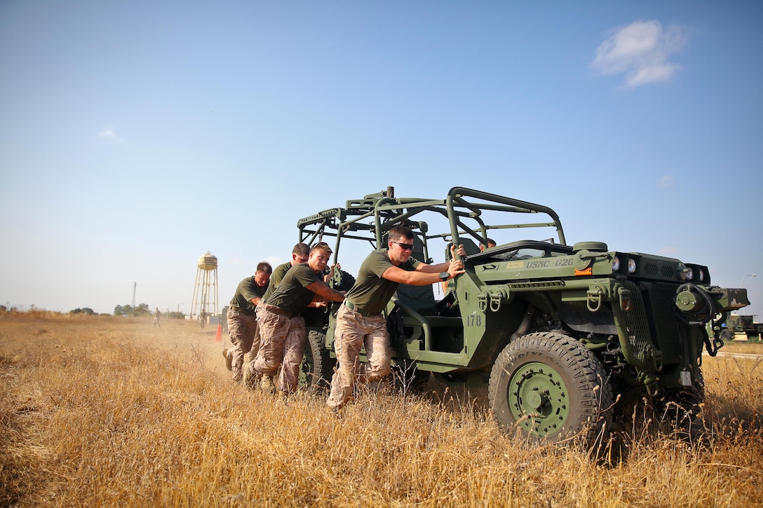 Marines with the ground combat element of Special Purpose Marine Air-Ground Task Force Crisis Response push an Internally Transportable Vehicle, or ITV, during a squad-based competitive training exercise at Moron Air Base, Spain, Aug. 27, 2013. SP-MAGTF Crisis Response is a self-mobile and self-sustaining force whose mission is to respond across a full range of military operations to protect both U.S. and partner-nation security interests in the region, as well as strengthening partnerships throughout the U.S. European Command and U.S. Africa Command area of responsibility. 