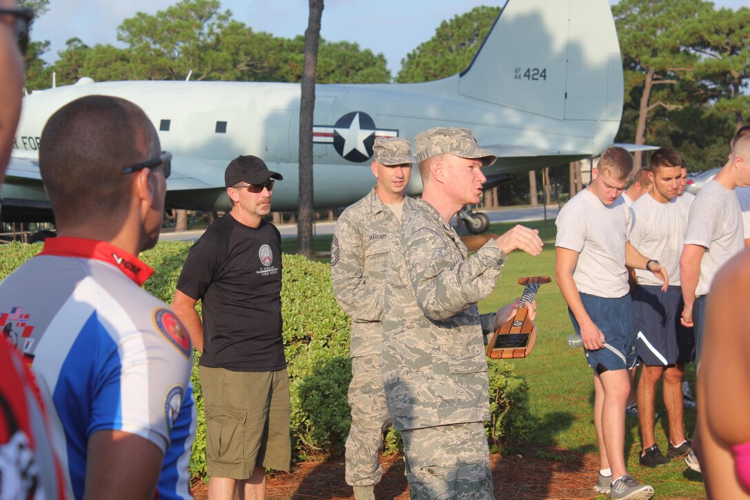 Servicemembers, members of the Gwinnett Sheriffs department and Georgia State Trooper stand during a ceremony with Col. William West, commander, 1st Special Operations Wing at the Air Force Special Operations Command headquarters, Sept. 4, 2013, at Hurlburt Field, Fla. Marines with U.S. Marine Corps Forces Special Operations Command were invited to ride in Operation One Voice Honor Ride to support wounded and deceased members of the U.S. Special Operations community.The Honor Ride this year was a 450-mile bike ride over a four day period. (U.S. Marine Corps courtesy photo/Released)