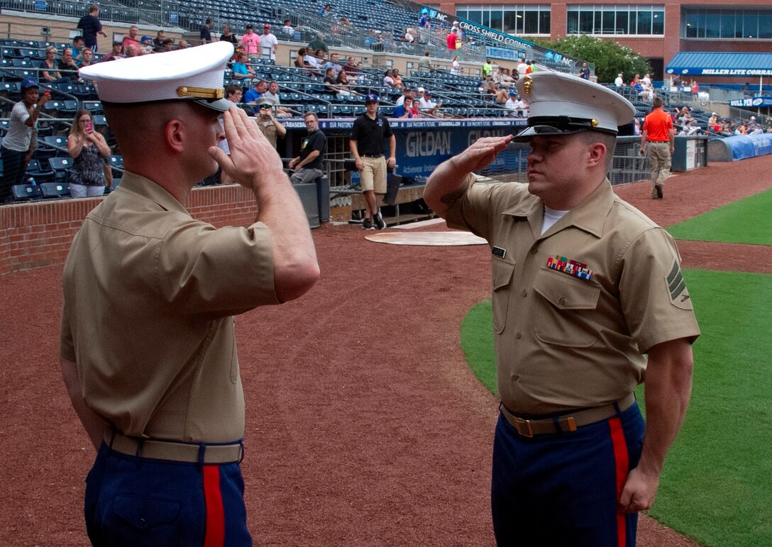 U.S. Marine Corps Sgt. David Carter, a recruiter with Recruiting Sub-Station Durham, reports to Capt. Jonathan Prather, the executive officer of Marine Corps Recruiting Station Raleigh, during an oath of enlistment ceremony at the Durham Bull Athletic Park in Durham, N.C., August 21, 2013. Poolees of RSS Durham took their oath of enlistment in front of Durham Bulls fans before the game. (U.S. Marine Corps photo by Sgt. Dwight A. Henderson/Released)