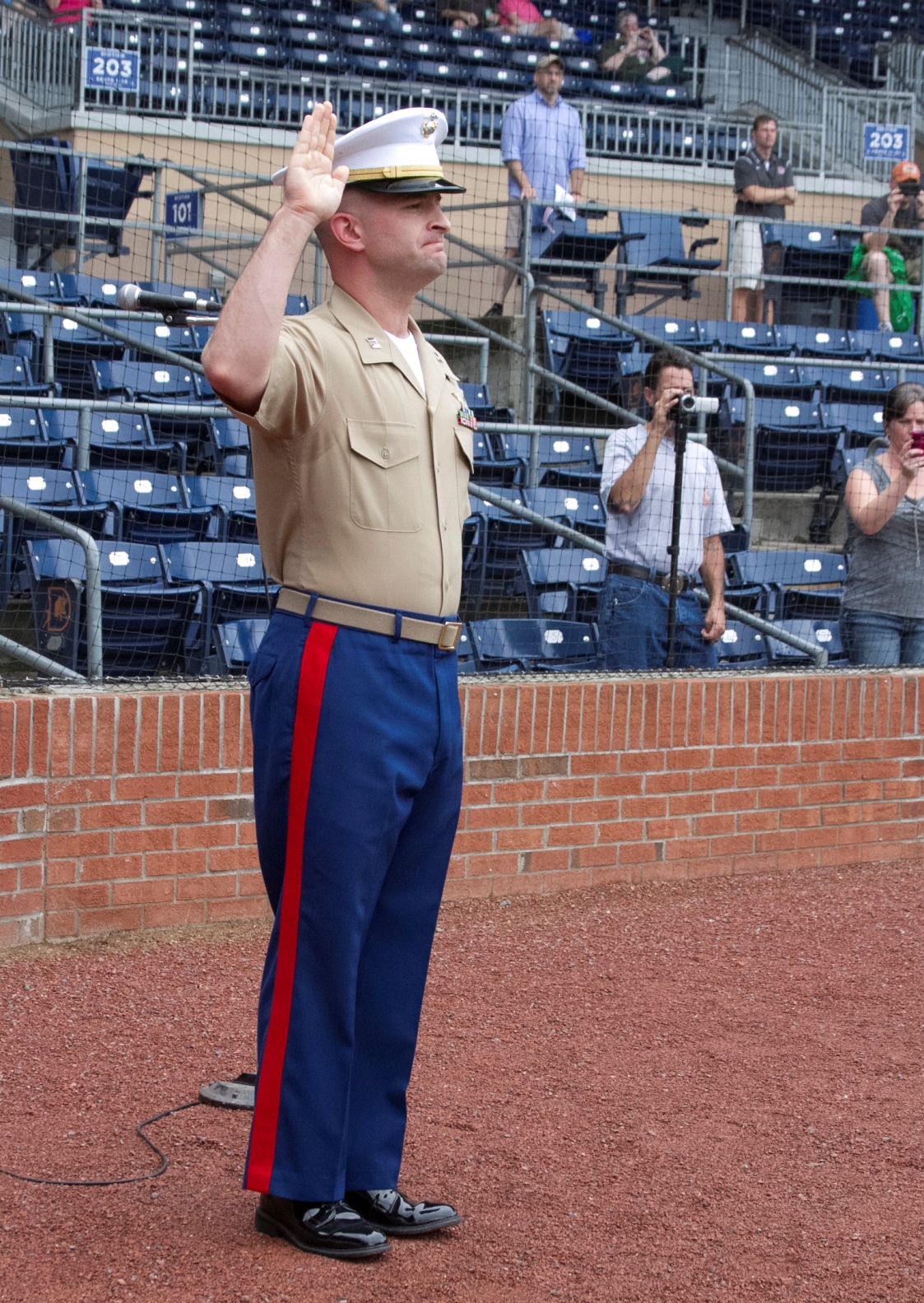 U.S. Marine Corps Capt. Jonathan Prather, the executive officer of Marine Corps Recruiting Station Raleigh, administers the oath of enlistment during an oath of enlistment ceremony at the Durham Bull Athletic Park in Durham, N.C., August 21, 2013. Poolees of Recruiting Sub-Station Durham took their oath of enlistment in front of Durham Bulls fans before the game. (U.S. Marine Corps photo by Sgt. Dwight A. Henderson/Released)
