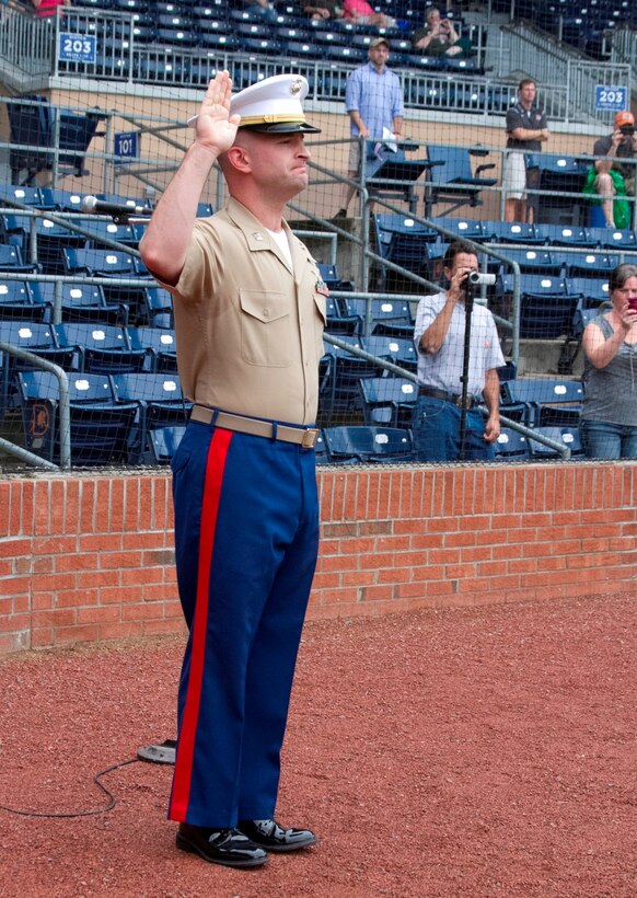 U.S. Marine Corps Capt. Jonathan Prather, the executive officer of Marine Corps Recruiting Station Raleigh, administers the oath of enlistment during an oath of enlistment ceremony at the Durham Bull Athletic Park in Durham, N.C., August 21, 2013. Poolees of Recruiting Sub-Station Durham took their oath of enlistment in front of Durham Bulls fans before the game. (U.S. Marine Corps photo by Sgt. Dwight A. Henderson/Released)