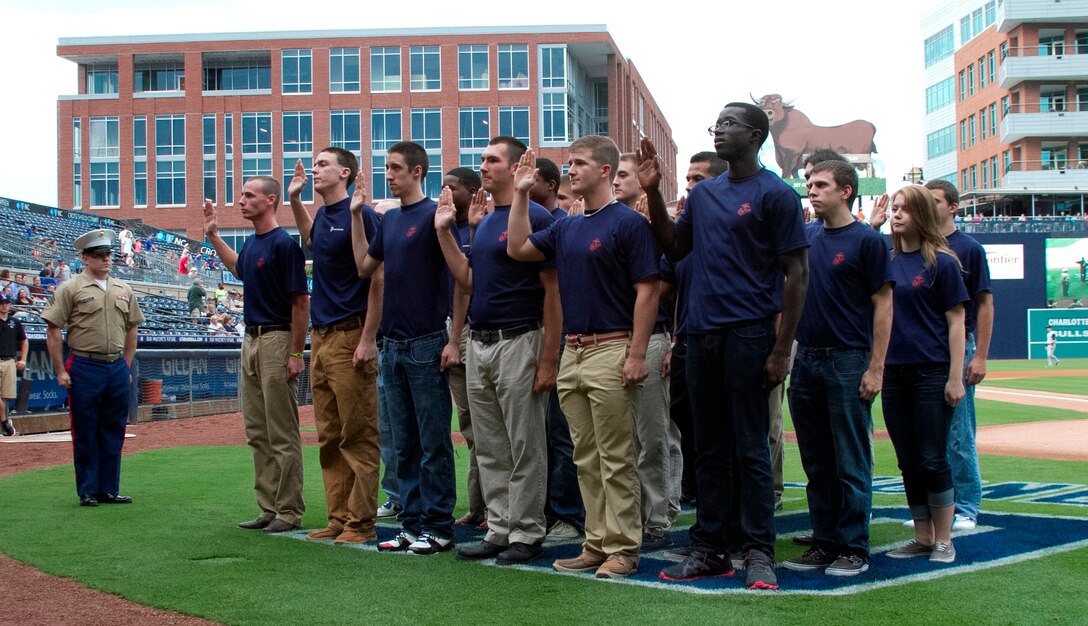 Marine Corps Poolees of Recruiting Sub-Station Durham take the oath of enlistment during an oath of enlistment ceremony at the Durham Bull Athletic Park in Durham, N.C., August 21, 2013. Poolees of RSS Durham took their oath of enlistment in front of Durham Bulls fans before the game. (U.S. Marine Corps photo by Sgt. Dwight A. Henderson/Released)