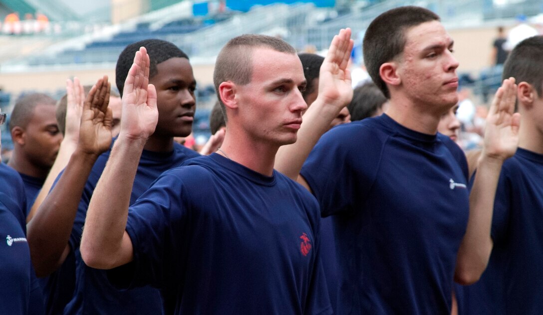 Marine Corps Poolees of Recruiting Sub-Station Durham take the oath of enlistment during an oath of enlistment ceremony at the Durham Bull Athletic Park in Durham, N.C., August 21, 2013. Poolees of RSS Durham took their oath of enlistment in front of Durham Bulls fans before the game. (U.S. Marine Corps photo by Sgt. Dwight A. Henderson/Released)