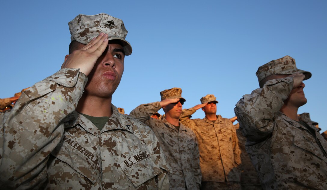 Marines salute during the retiring of the colors during an evening colors ceremony hosted by 3rd Marine Aircraft Wing and Marine Corps Air Station Miramar aboard the air station, Sept. 11. 