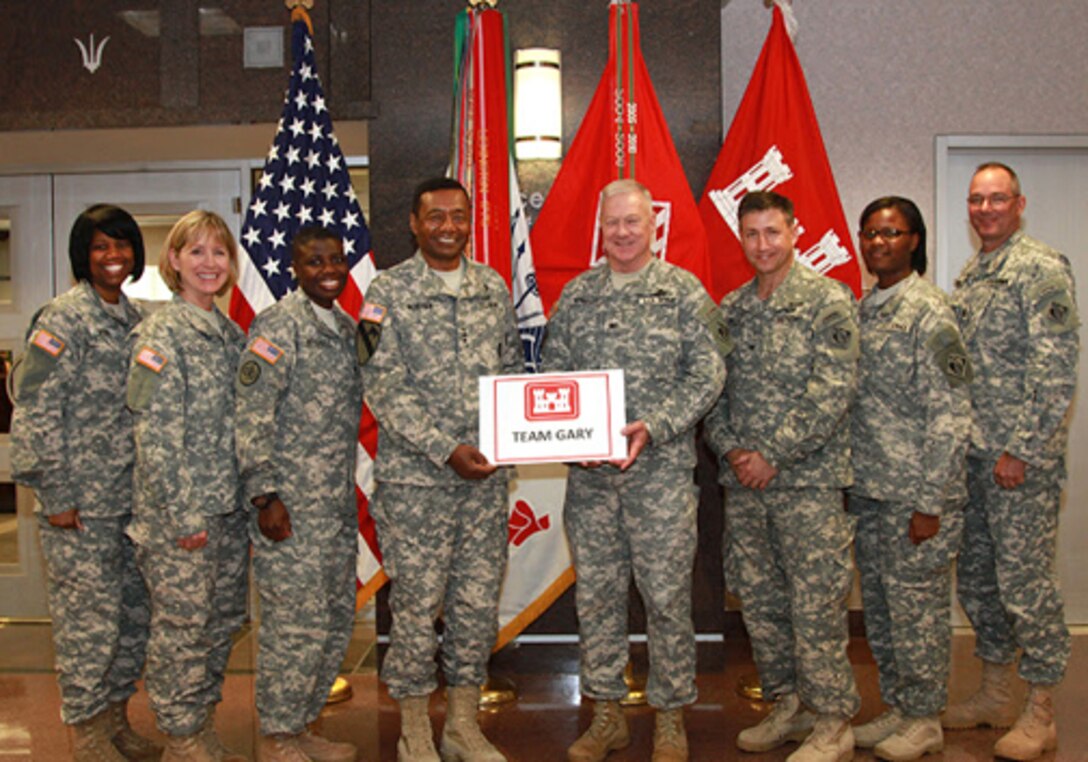 Corps of Engineers commander Lt. Gen. Thomas Bostick, Corps chaplain Col. Phillip Wright and staff members hold a “Team Gary” sign in June at Corps headquarters in Washington.  