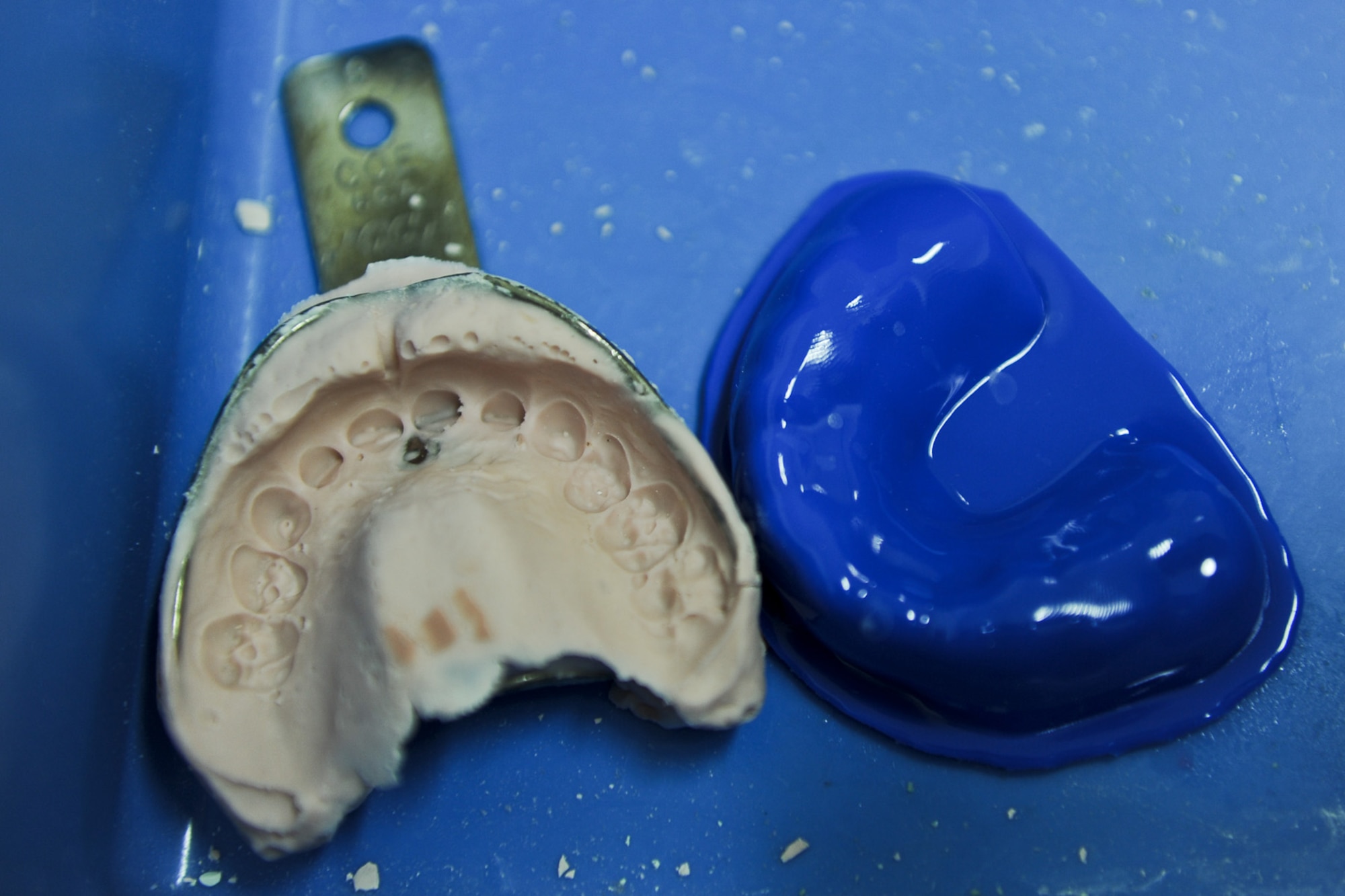 A dental impression sits next to a mouth guard Sept. 7, 2013, at Yokota Air Base, Japan. The 374th Dental Squadron hosted a one-day mouth guard clinic for patients wanting customized mouth guards. Patients who were unable to attend the mouth guard clinic, and still need one, can schedule an appointment with the dental squadron. (U.S. Air Force photo by Senior Airman Desiree Economides/Released)