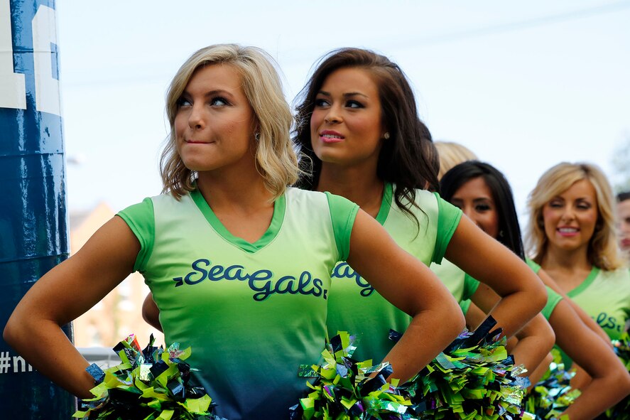 Athletes from the Seattle Seahawks "Sea Gals" drill team at the Warrior Zone, Joint Base Lewis-McChord, Wash., Sept. 10. The Seahawks officially adopted the 446th Airlift Wing as their military unit of the 2013 NFL season. The Seahawks “12th Man” flag was transferred to the 446th AW from the 4th Stryker Brigade Combat Team (SBCT), 2nd Infantry Division as part of a "change of command" ceremony. The athletes had a brief meet and greet with the Airmen and Soldiers before they departed. The flag will travel with the Citizen Airman all over the world until the 2014 season. (U.S. Air Force Reserve Photo by Master Sgt. Jake Chappelle)