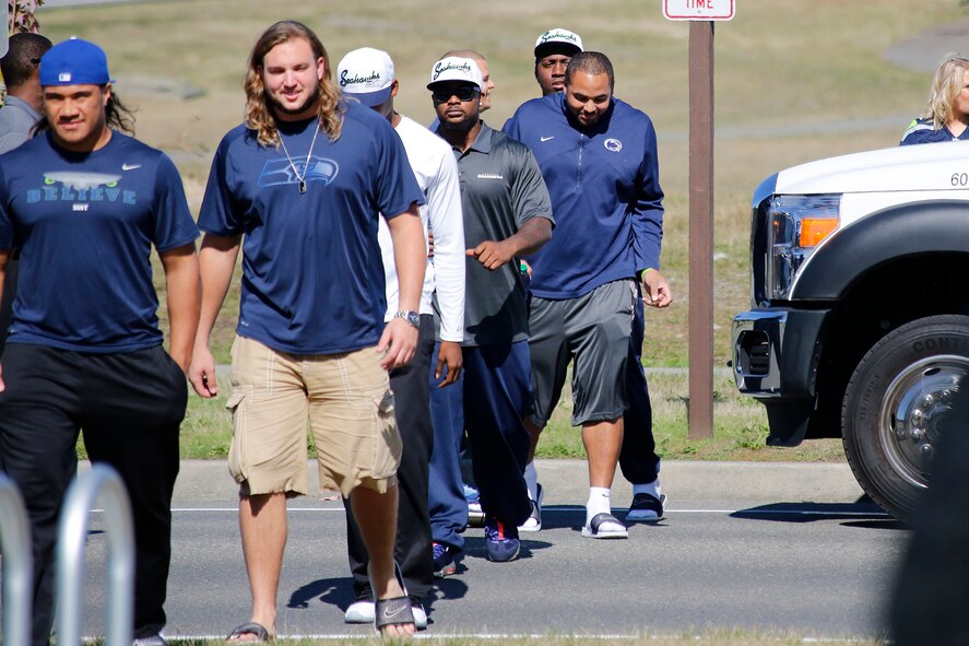 Athletes from the Seattle Seahawks football team arrive at the Warrior Zone, Joint Base Lewis-McChord, Wash., Sept. 10. The Seahawks officially adopted the 446th Airlift Wing as their military unit of the 2013 NFL season. The Seahawks “12th Man” flag was transferred to the 446th AW from the 4th Stryker Brigade Combat Team (SBCT), 2nd Infantry Division as part of a "change of command" ceremony. The athletes had a brief meet and greet with the Airmen and Soldiers before they departed. The flag will travel with the Citizen Airman all over the world until the 2014 season. (U.S. Air Force Reserve Photo by Master Sgt. Jake Chappelle)