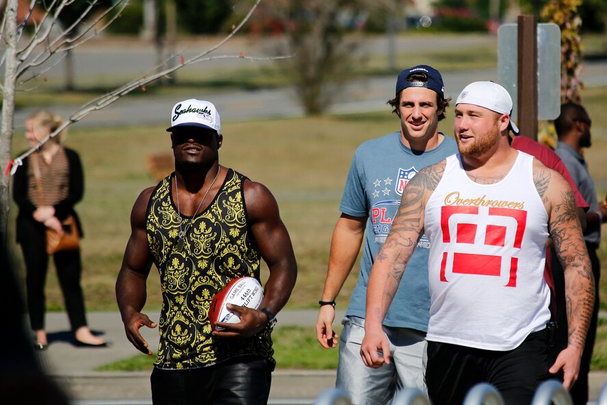 Athletes from the Seattle Seahawks football team arrive at the Warrior Zone, Joint Base Lewis-McChord, Wash., Sept. 10. The Seahawks officially adopted the 446th Airlift Wing as their military unit of the 2013 NFL season. The Seahawks “12th Man” flag was transferred to the 446th AW from the 4th Stryker Brigade Combat Team (SBCT), 2nd Infantry Division as part of a "change of command" ceremony. The athletes had a brief meet and greet with the Airmen and Soldiers before they departed. The flag will travel with the Citizen Airman all over the world until the 2014 season. (U.S. Air Force Reserve Photo by Master Sgt. Jake Chappelle)