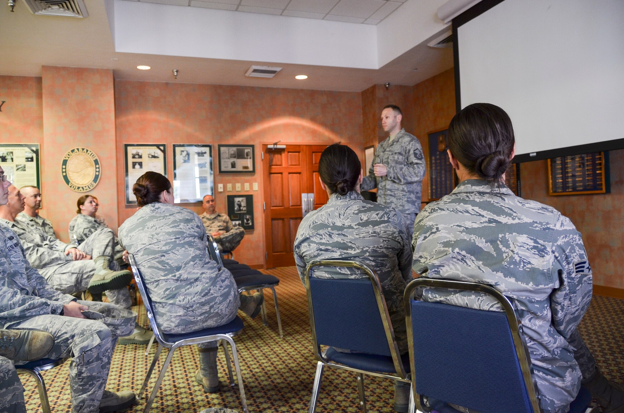 Members from 12th Air Force (Air Forces Southern) listen while Master Sgt. Nathan Clark, 612th Operations Superintendent, speaks during the Sexual Assault Prevention and Response down day at Davis-Monthan Air Force Base, Ariz., Sept. 5, 2013. The purpose of the down day was to take a pause in the day-to-day mission to reiterate zero tolerance of sexual assault and focus on fostering a climate of dignity and respect in the Air Force. Military leaders from every level call on Airmen to not be part of the problem, but part of the solution in the movement toward a new culture that aims to rid sexual assault from the ranks. (U.S. Air Force photo by Staff Sgt. Adam Grant/Released)