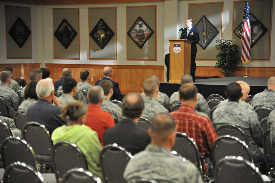 1st Lt. Jessica White, 341st Contracting Squadron government purchase card program manager, sings “America the Beautiful” during the 9/11 remembrance ceremony at the Grizzly Bend. Chief Master Sgt. Frank Fidani, 341st Missile Wing command chief, then provided preparation for the wreath laying. (U.S. Air Force photo/John Turner)