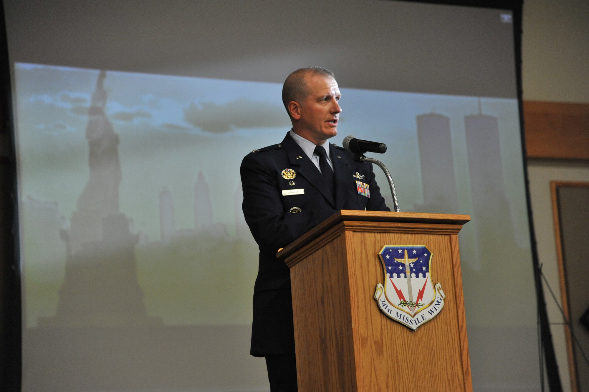 Col. Robert Stanley, 341st Missile Wing commander, provides words of remembrance to Team Malmstrom members at the Grizzly Bend during the We Will Never Forget 9/11 remembrance ceremony. The ceremony included a presentation of the colors provided by the Malmstrom Honor Guard, a scripture reading, a wreath laying and moment of silence. (U.S. Air Force photo/John Turner)